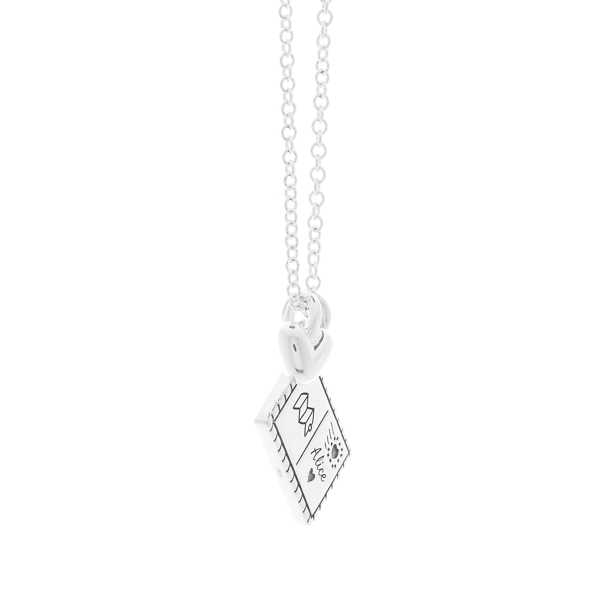 Silver postcard and heart necklace with engraving on a white background side view