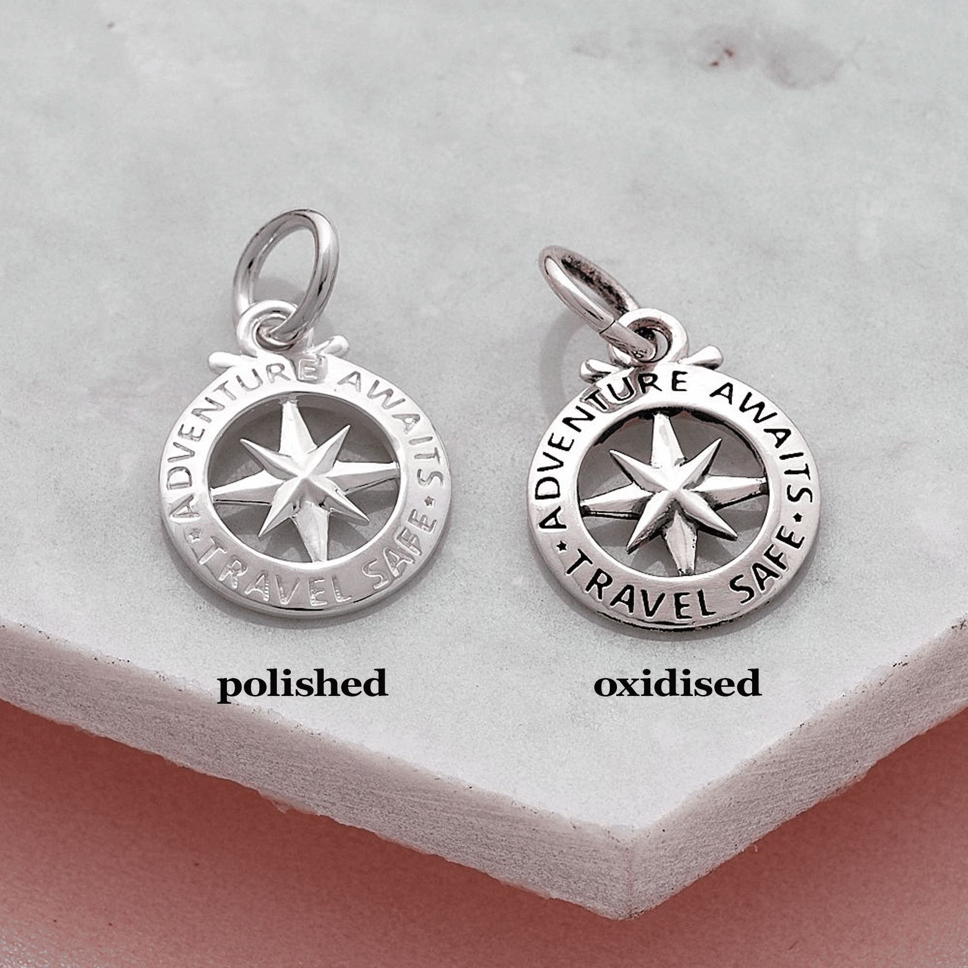 Two silver compass pendants labeled 'polished' and 'oxidised' with travel safe adventure awaits engraving