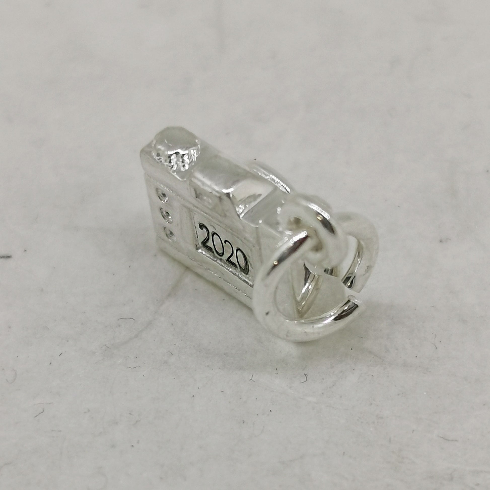 silver camera charm engraved with year