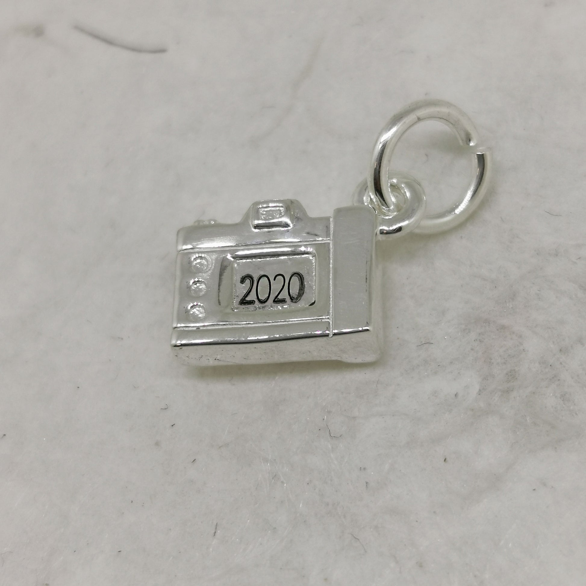 silver camera charm engraved with year