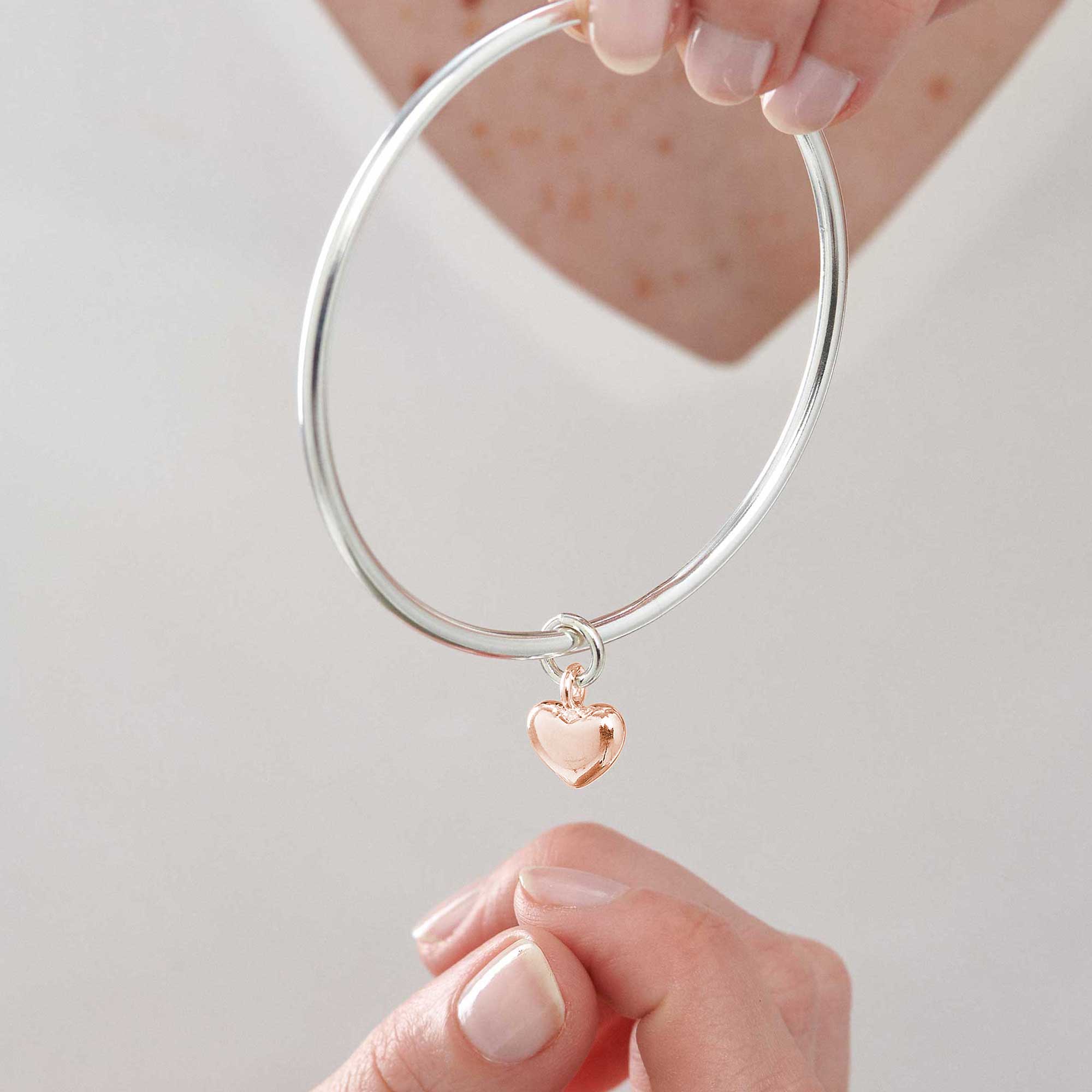 womens bangle bracelet designer UK made with solid rose gold heart on silver bangle