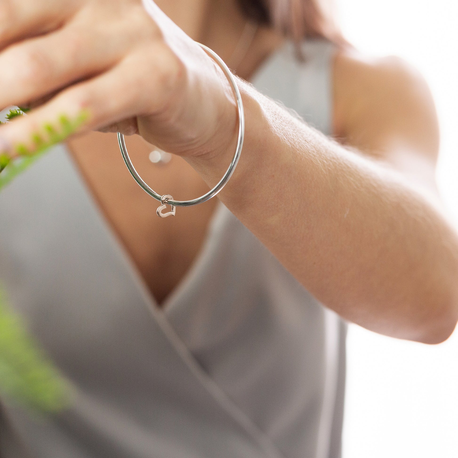 silver bangle with rose gold open heart