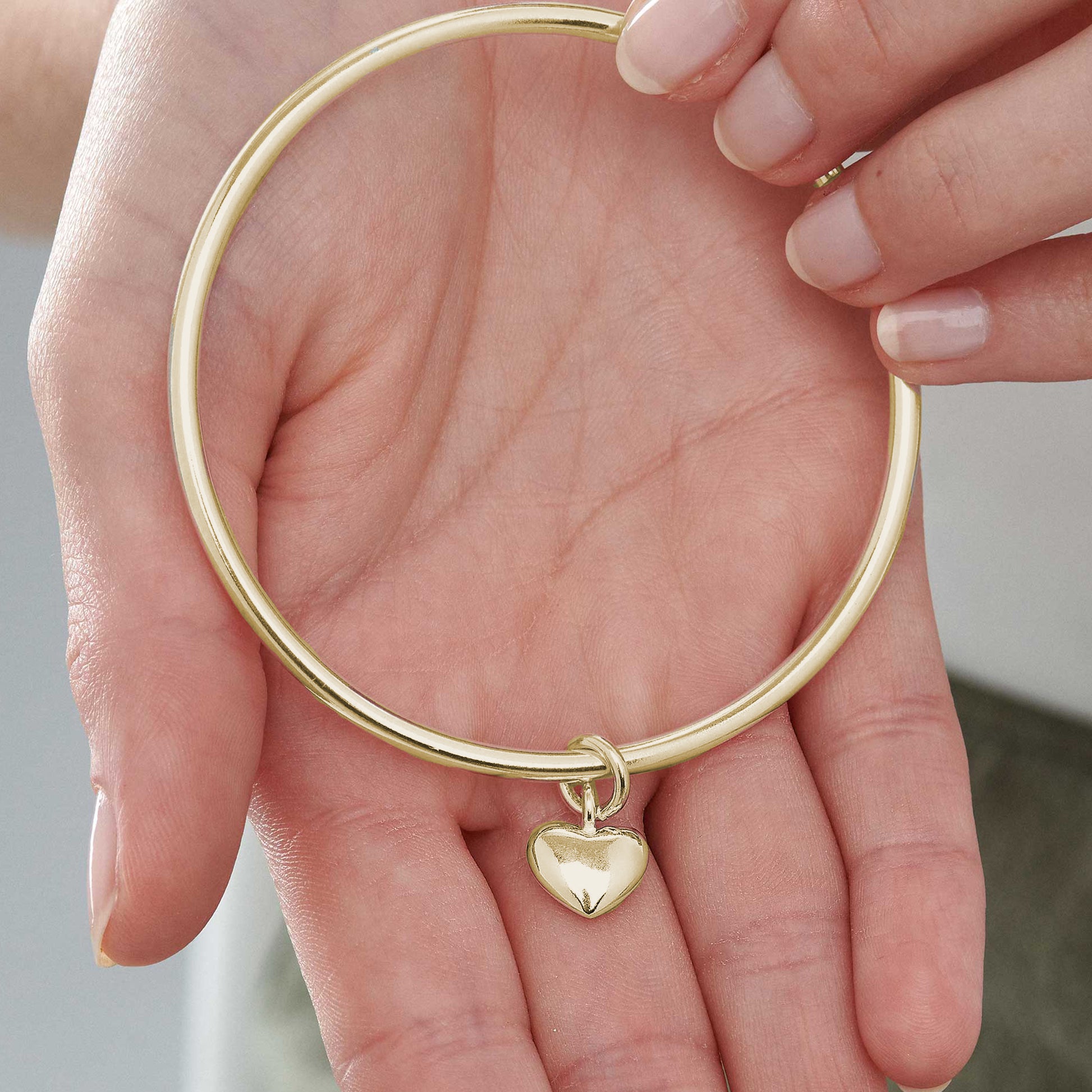 recycled solid 9k gold bangle for women with heart charm stacking bracelet bangle solid fine gold scarlett jewellery Brighton UK