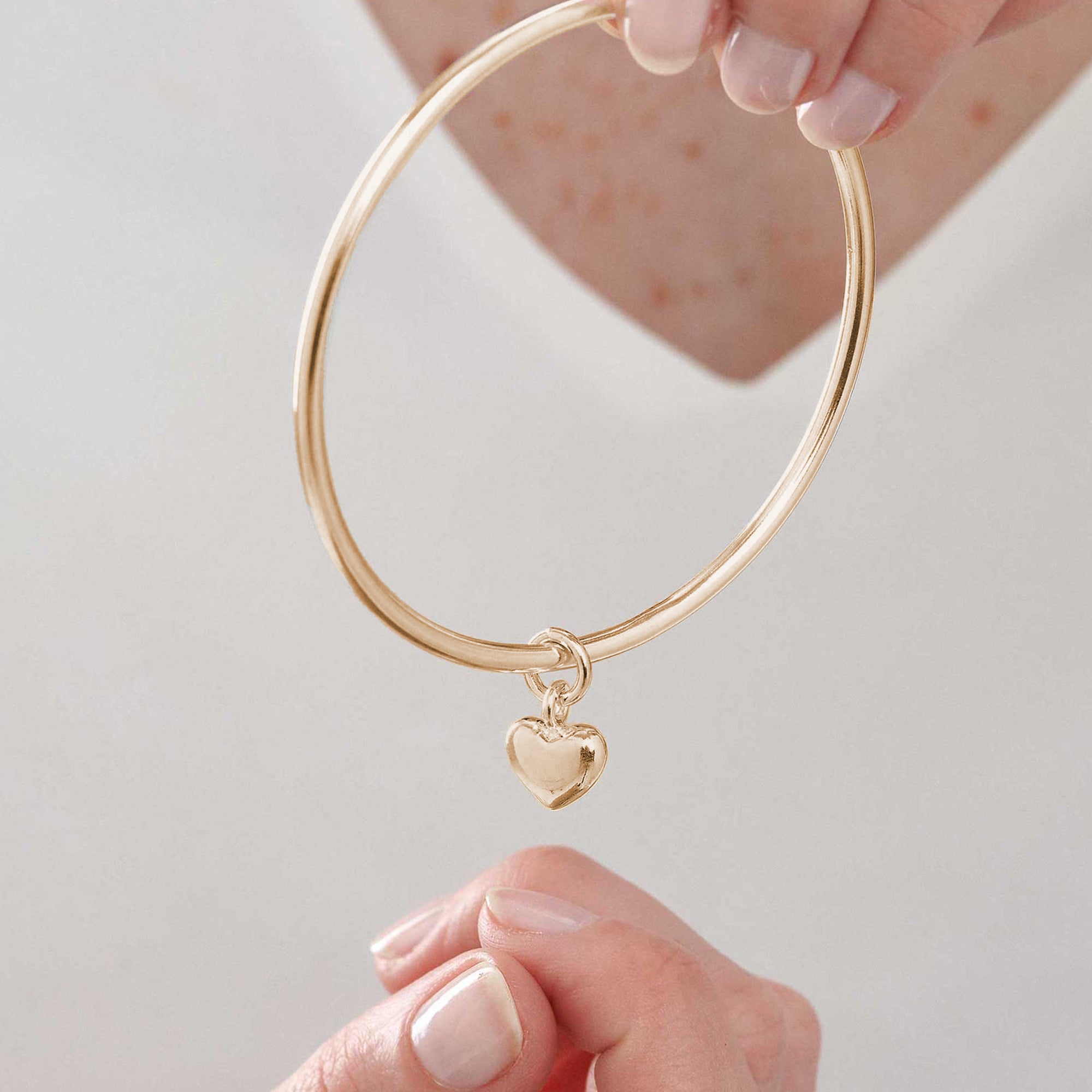 recycled solid 9k gold bangle for women with heart charm stacking bracelet bangle solid fine gold scarlett jewellery Brighton UK