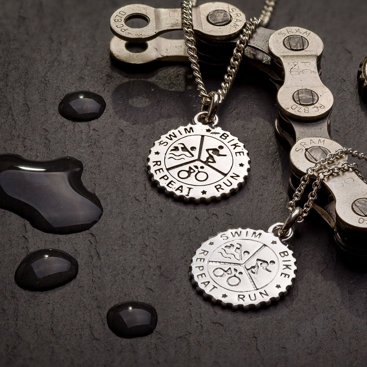 Men's and women's silver triathlon pendant necklace 'swim bike run repeat'
