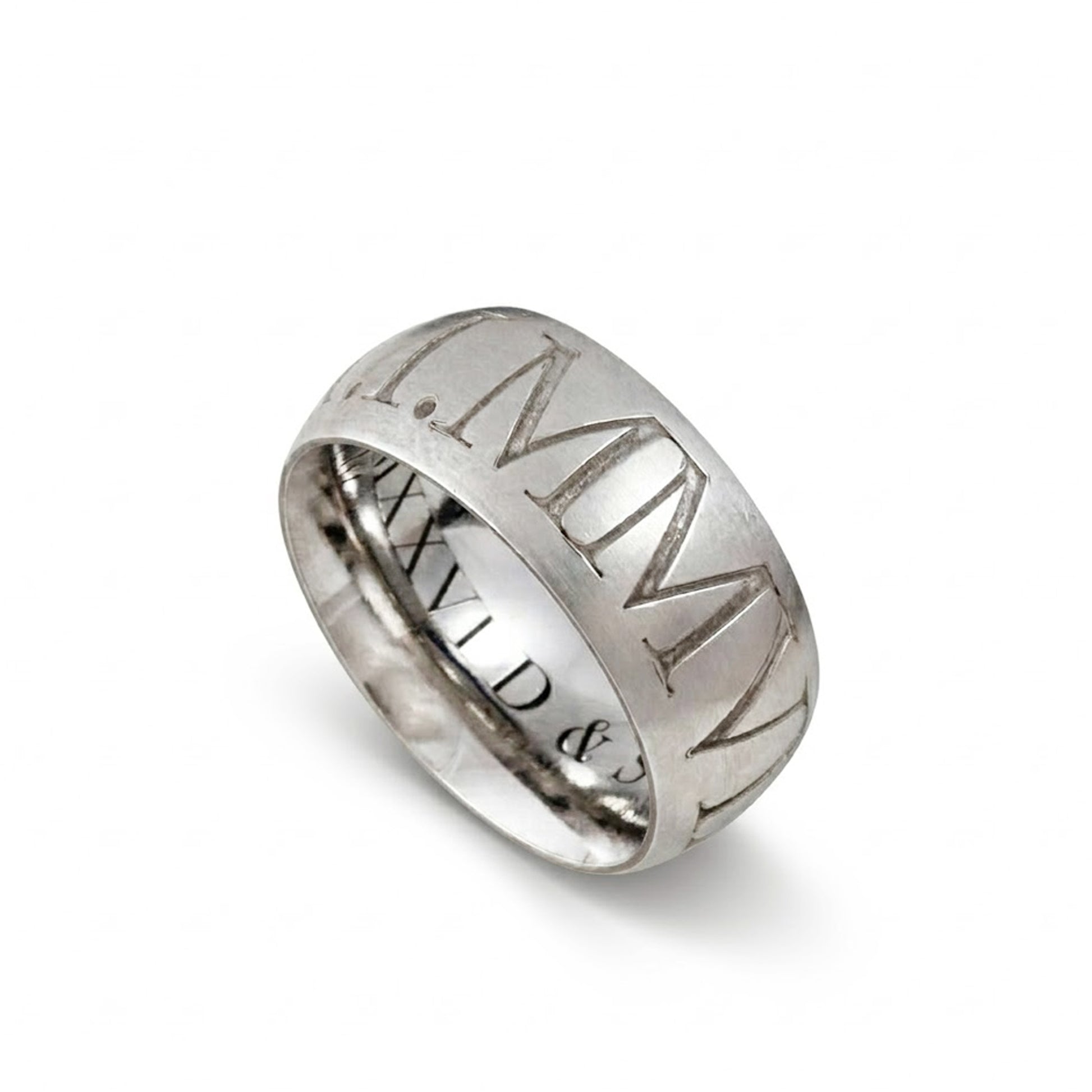 Silver ring with Roman numeral engraving on a white background