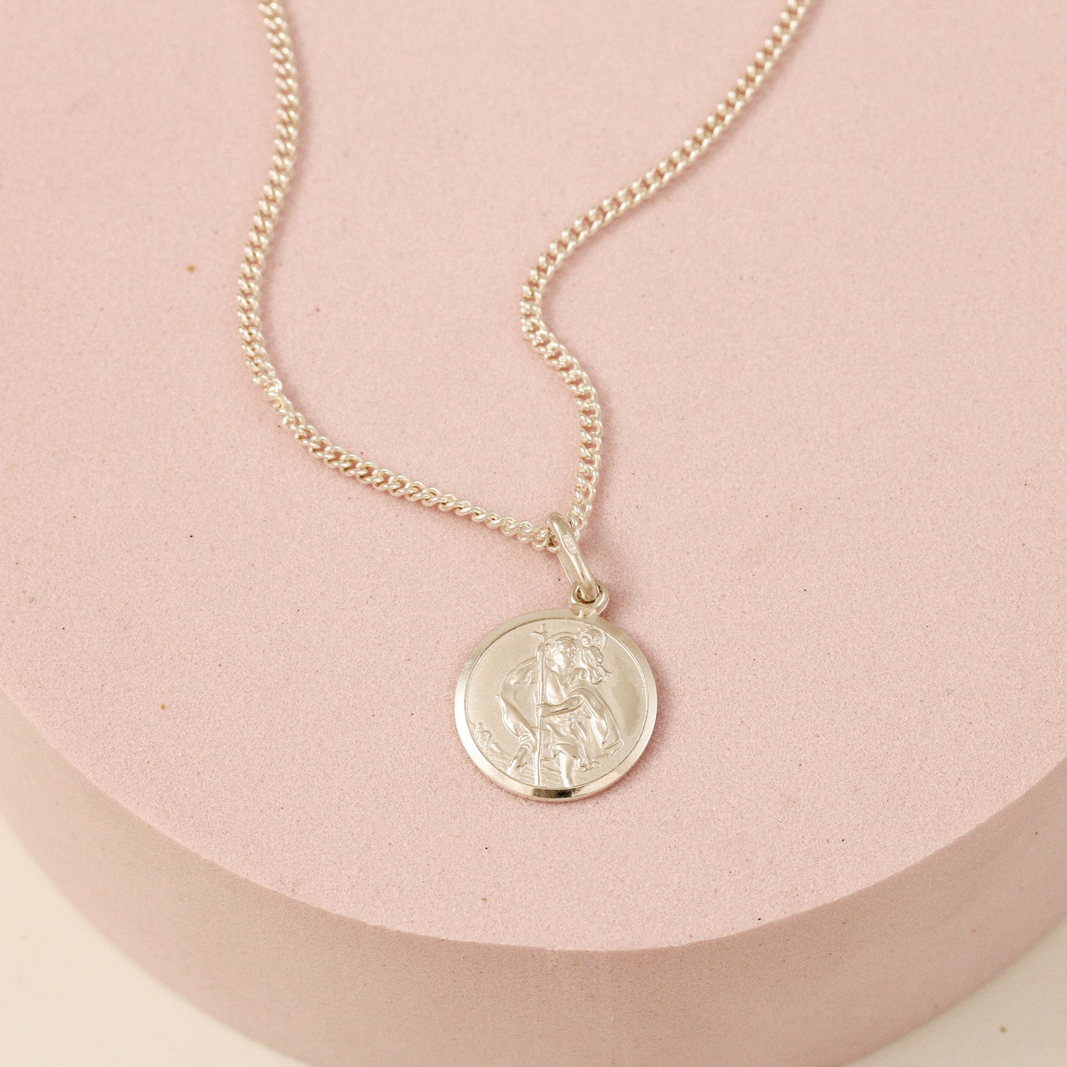 Small silver saint christopher necklace on heavier curb chain