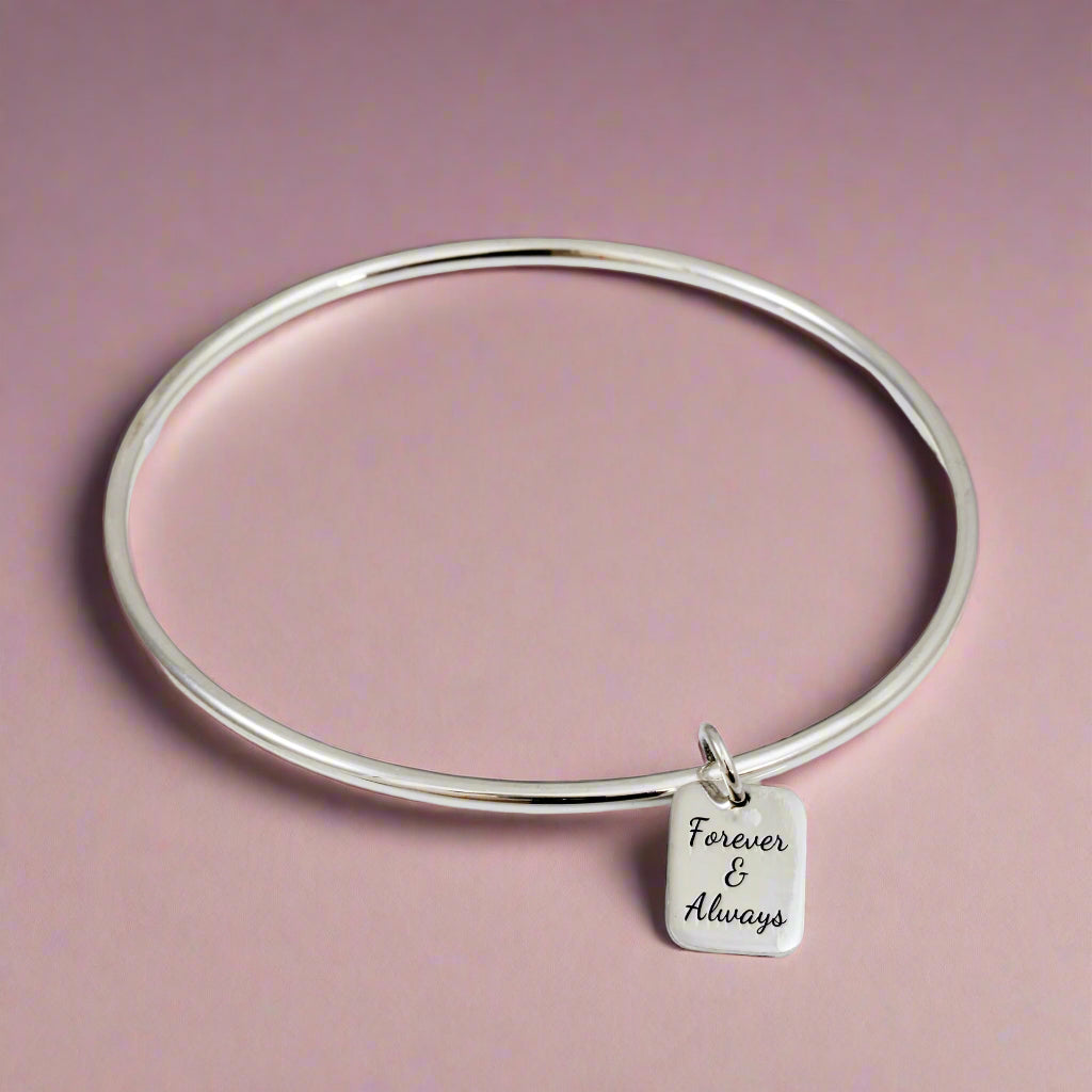 silver bangle with personalised tag charm