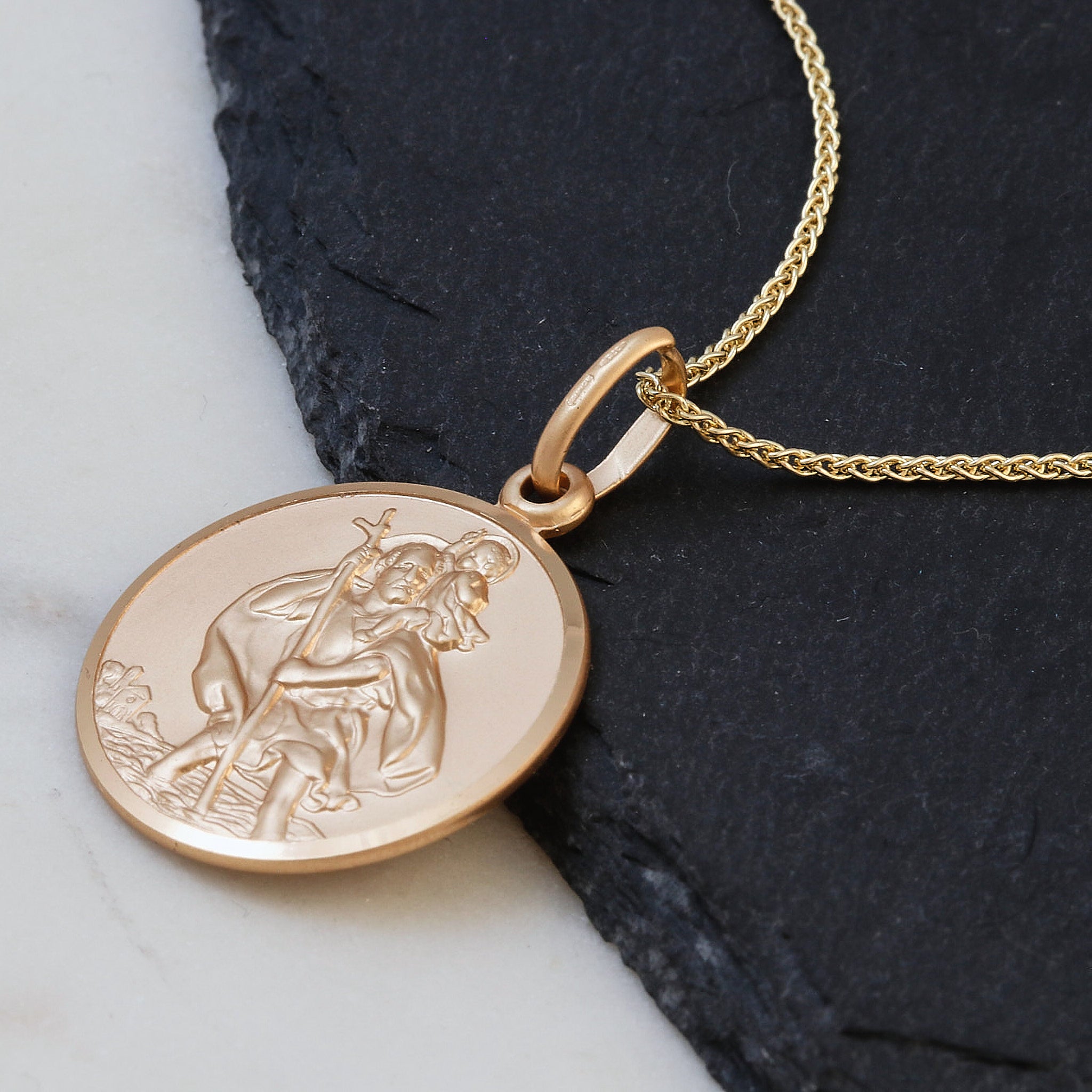 Gold pendant necklace with a saint christopher on light spiga chain
