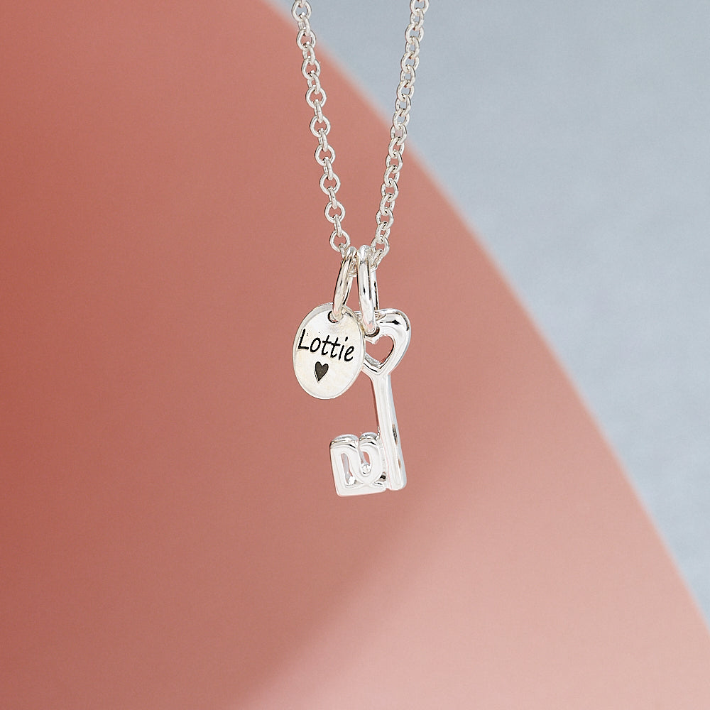 Silver necklace 21st birthday with key and heart-shaped pendant on a gradient background