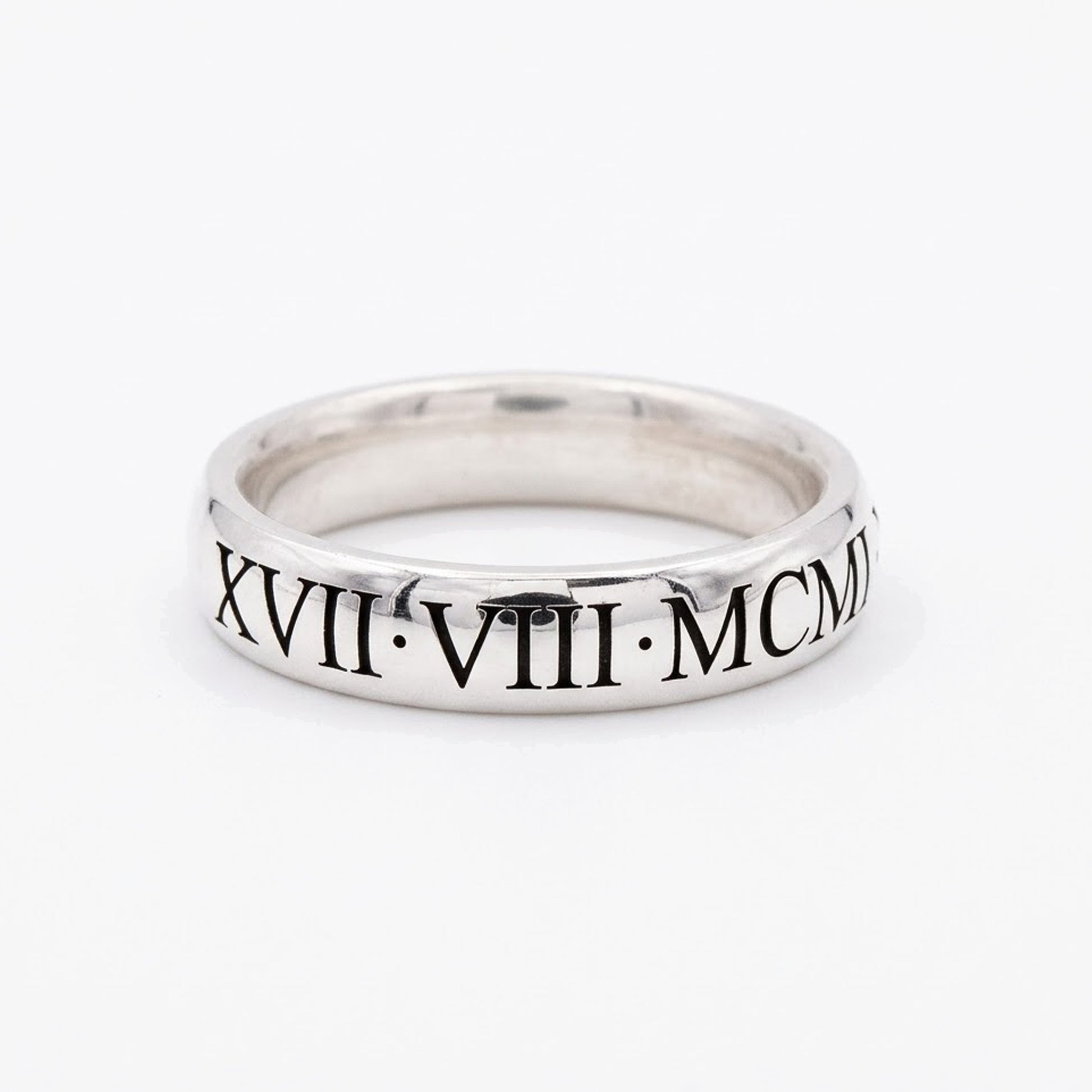 Silver ring with Roman numerals on a white background
