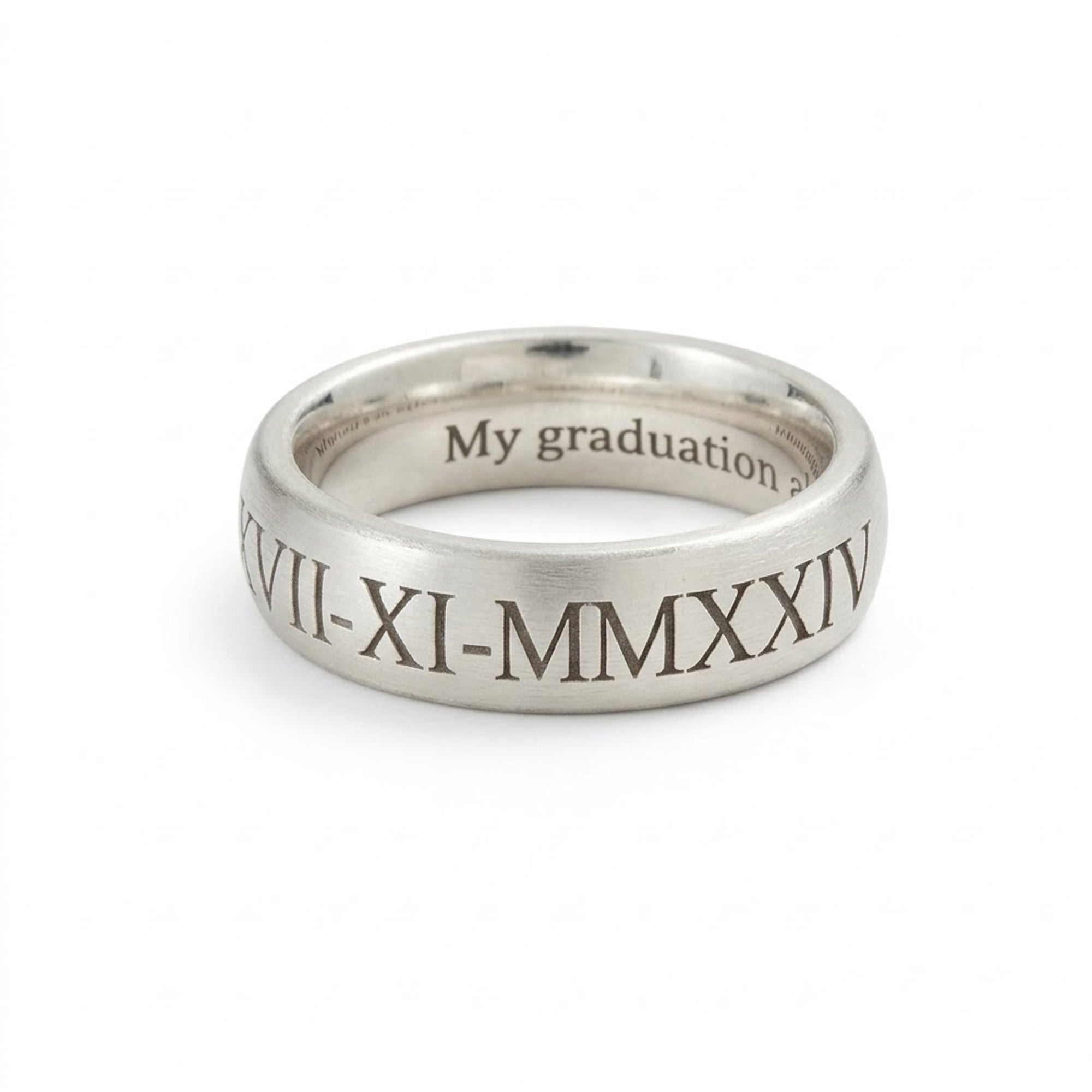 Silver ring with engraved text on a white background
