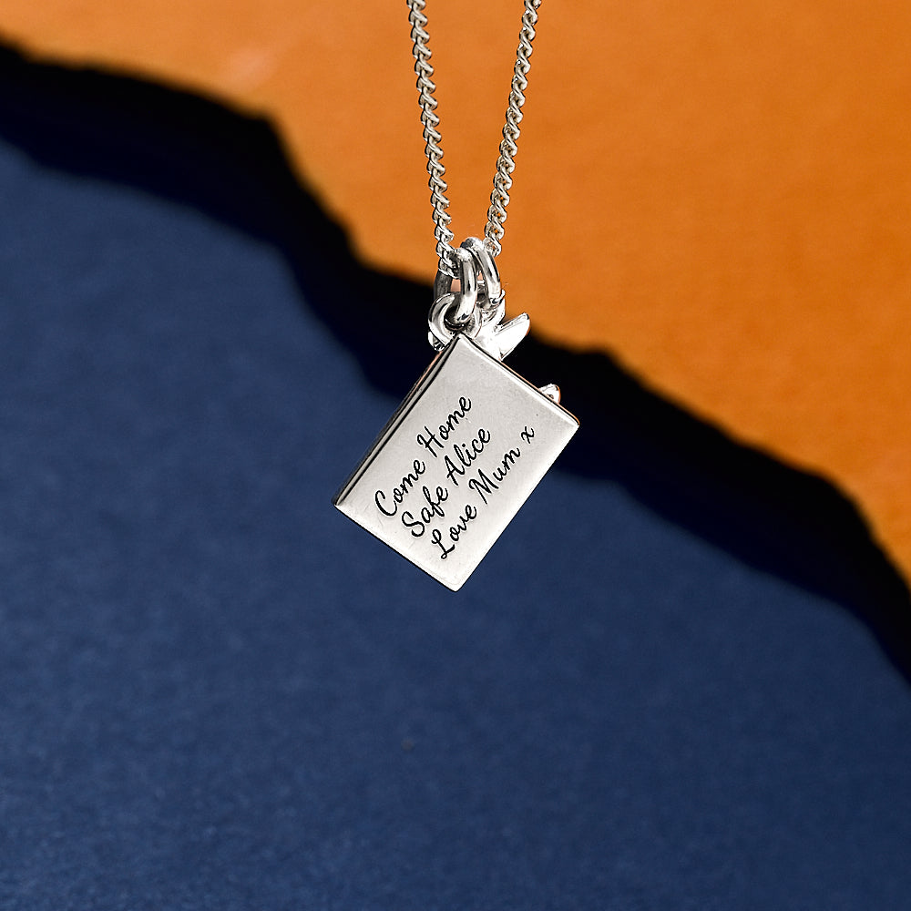 back of postcard travel necklace with air plane
