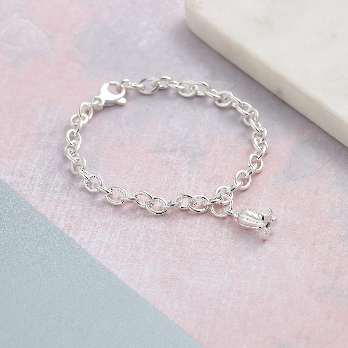 Complete silver charm bracelet featuring handcrafted bluebell flower charm as centrepiece