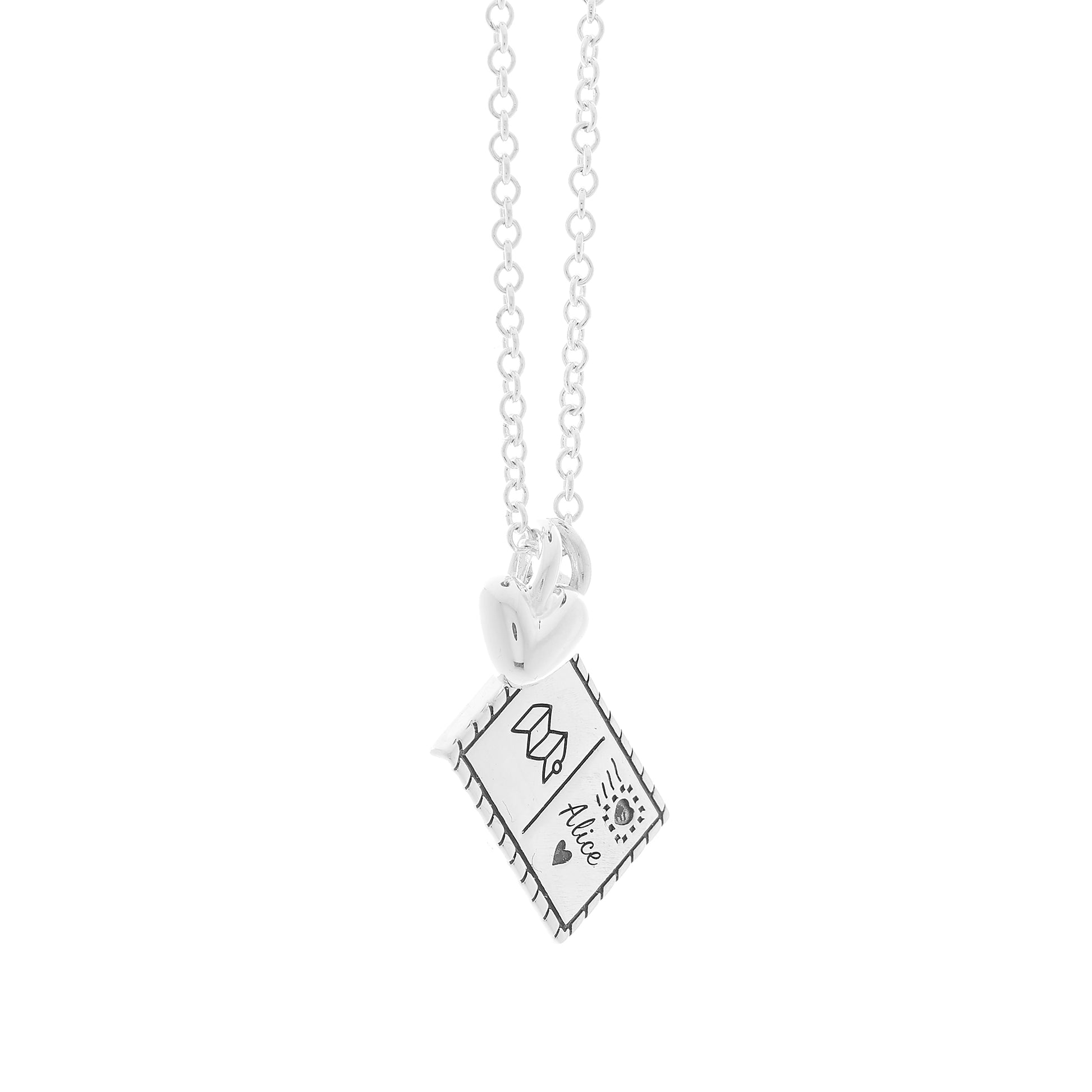 Silver postcard and heart necklace with engraving on a white background