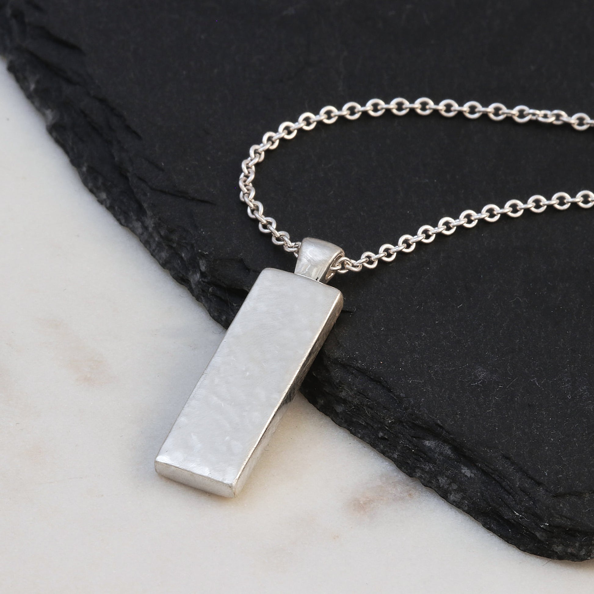 back of hammered roman numerals pendant