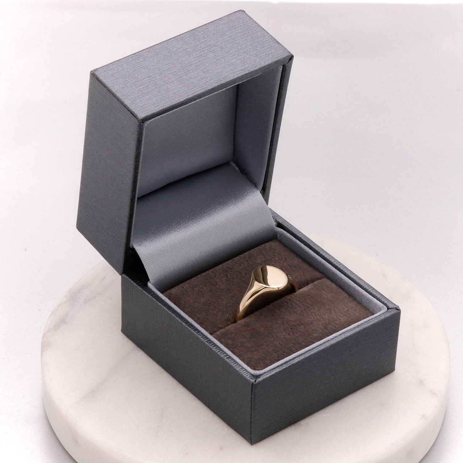 gold signet ring in luxury gift box