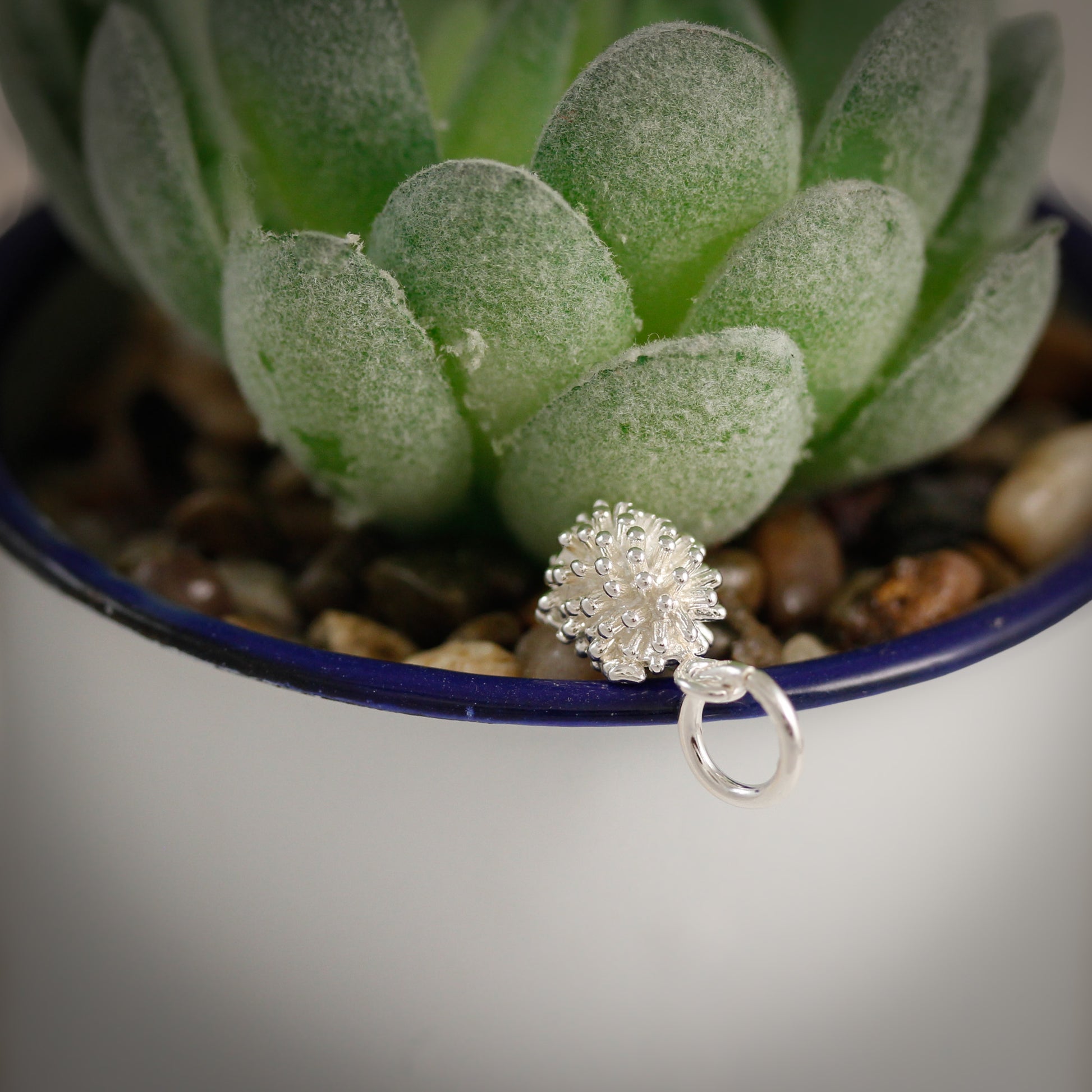 back of silver hedgehog charm