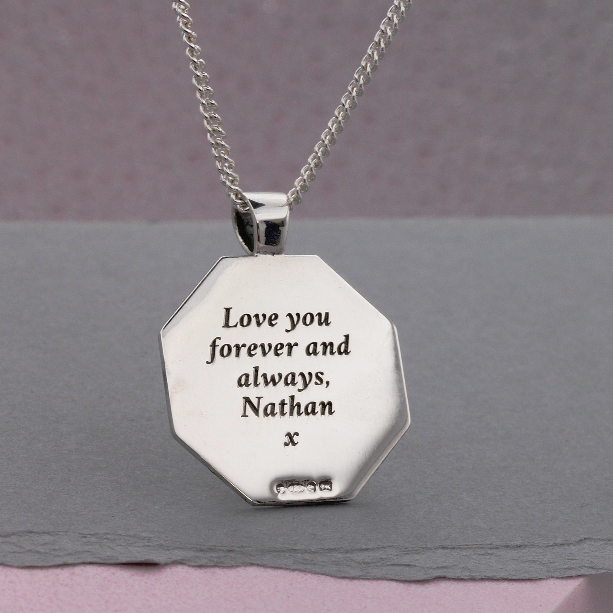 back of engraved octagon shaped pendant in silver