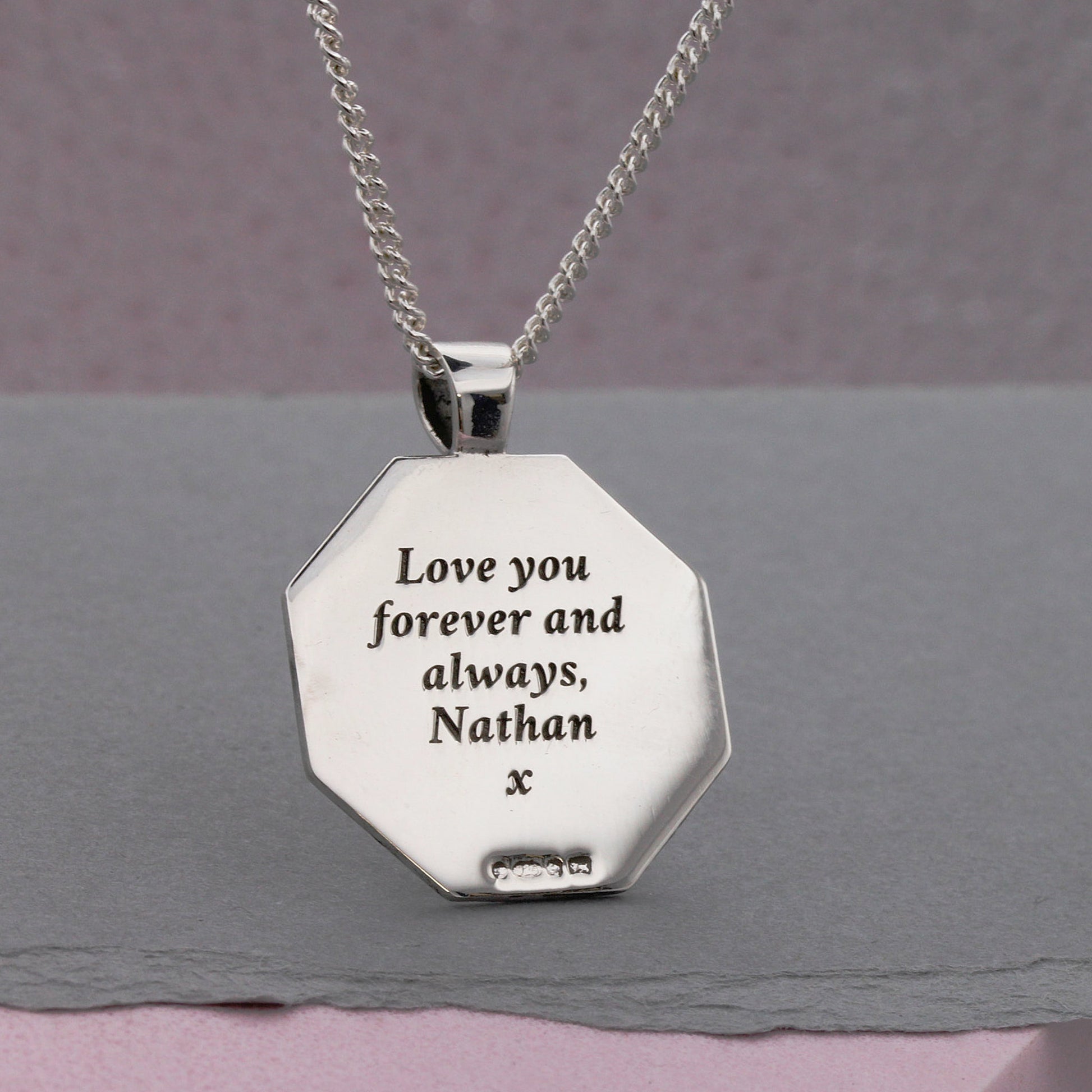 back of engraved octagon shaped pendant in silver
