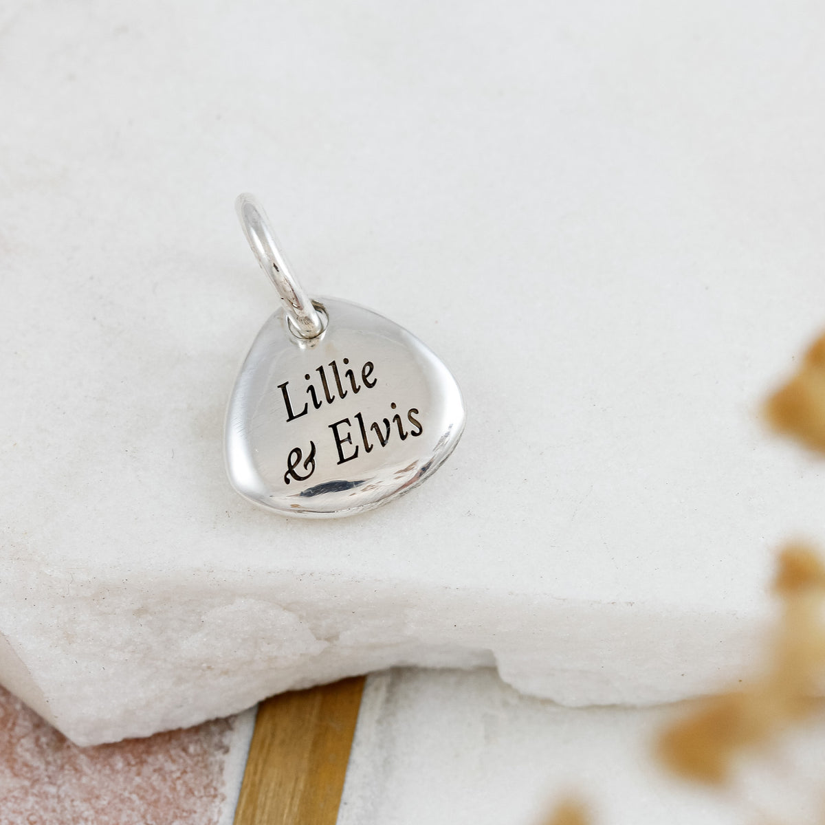 pet paw charm with engraved names on the back