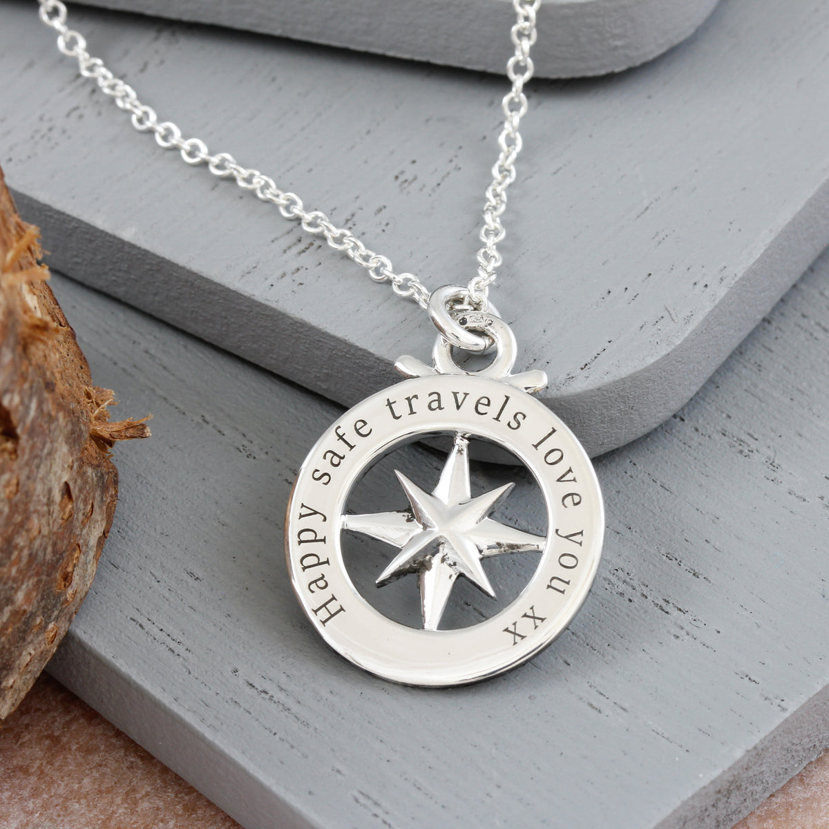 engraved good luck message on back of small compass necklace