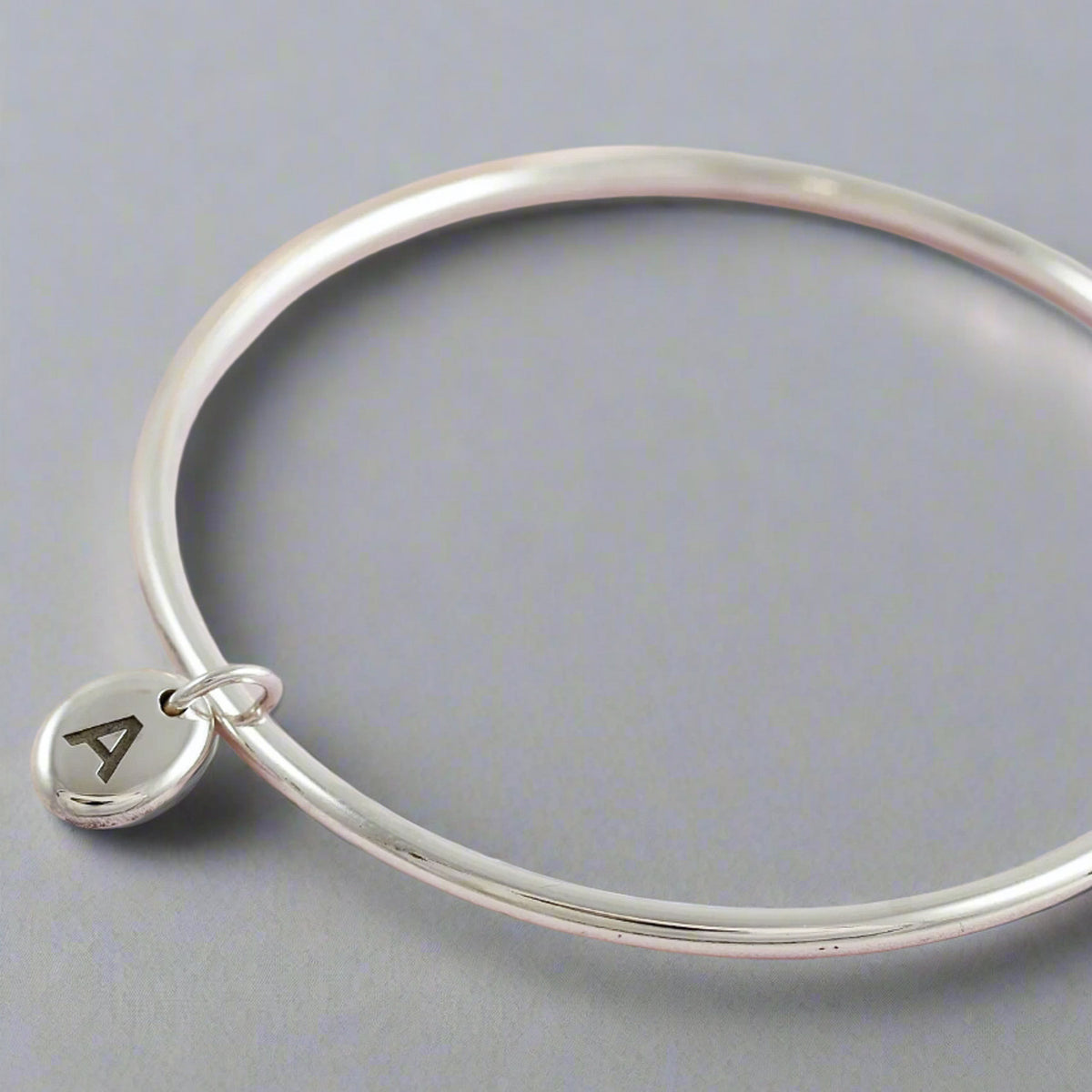 silver bangle with A initial on charm