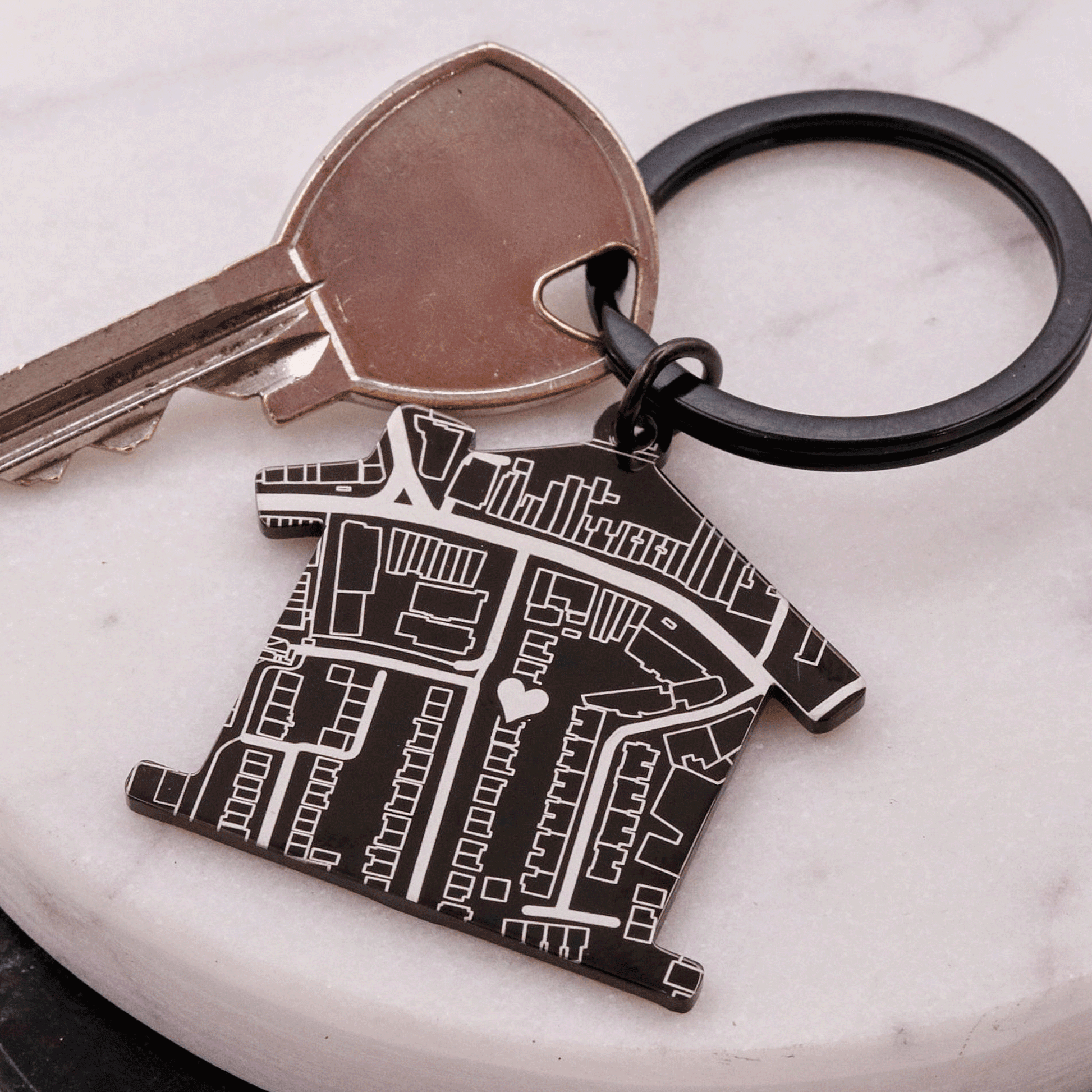 Black house shaped silver keyring with map design