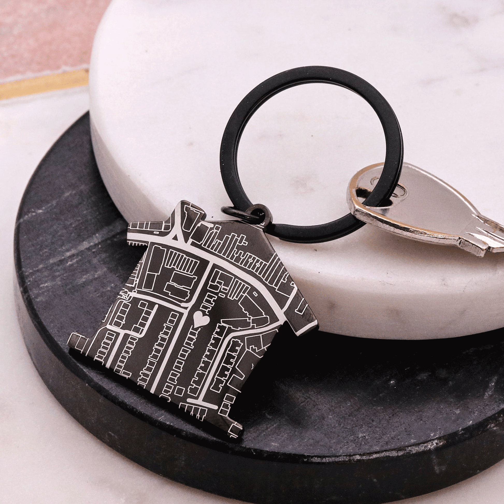Black house shaped silver keyring with map design