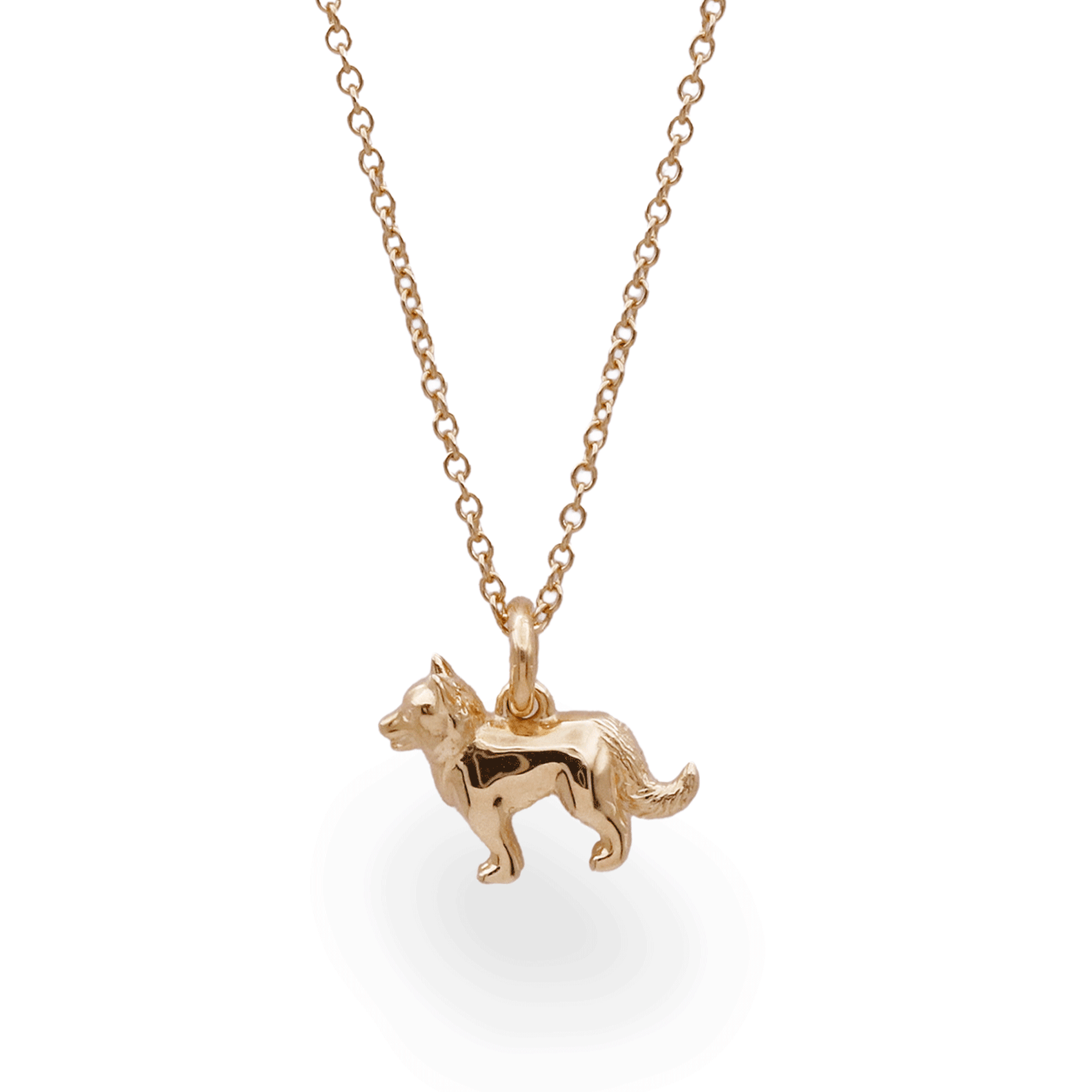 Gold dog-shaped pendant on a chain against a white background