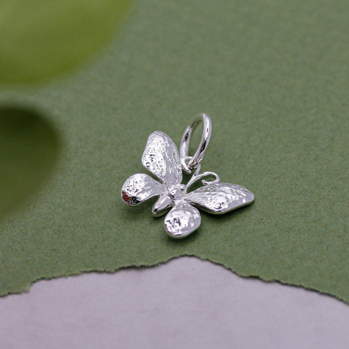 Silver butterfly charm showing intricate wing details and craftsmanship