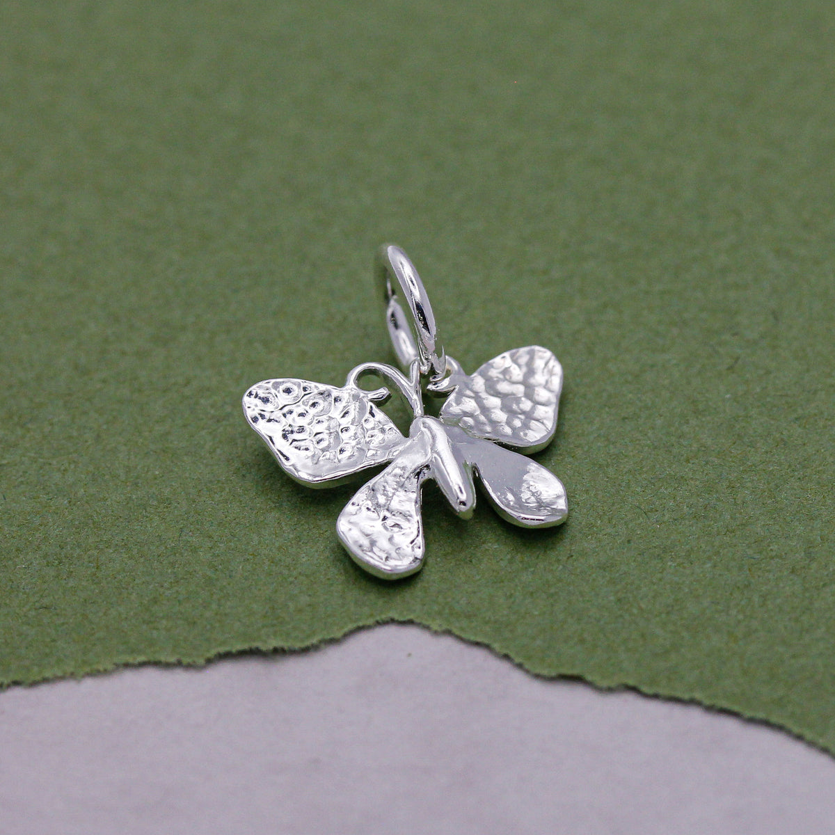 Close-up of sterling silver butterfly charm showing delicate wing patterns