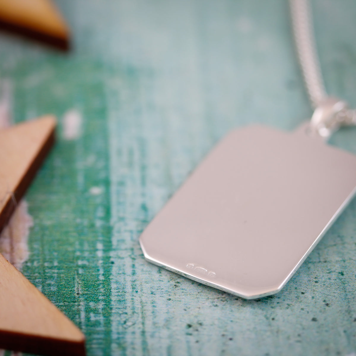 back of silver dog tag Saint Christopher showing hallmark