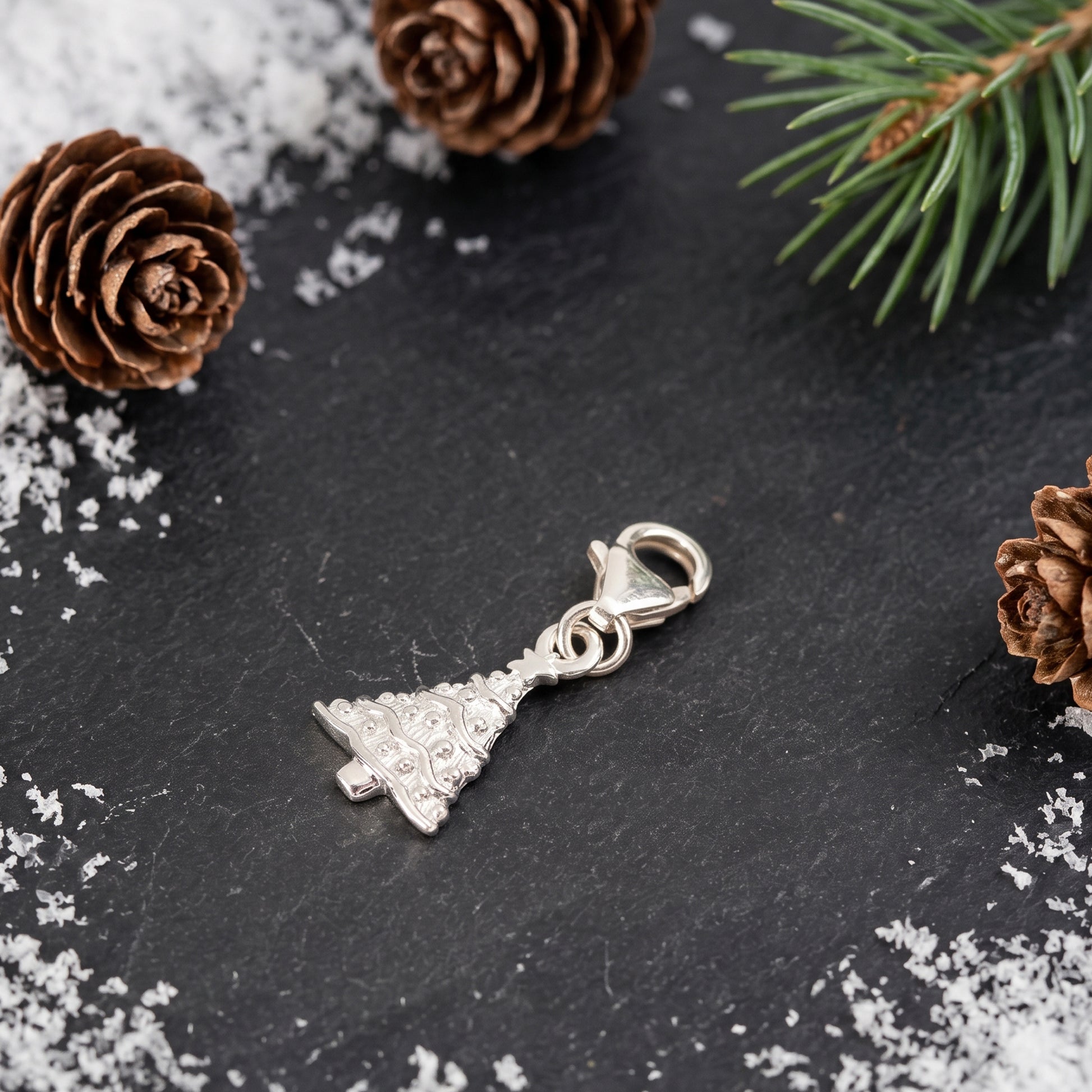 Christmas tree charm with clip clasp on festive background
