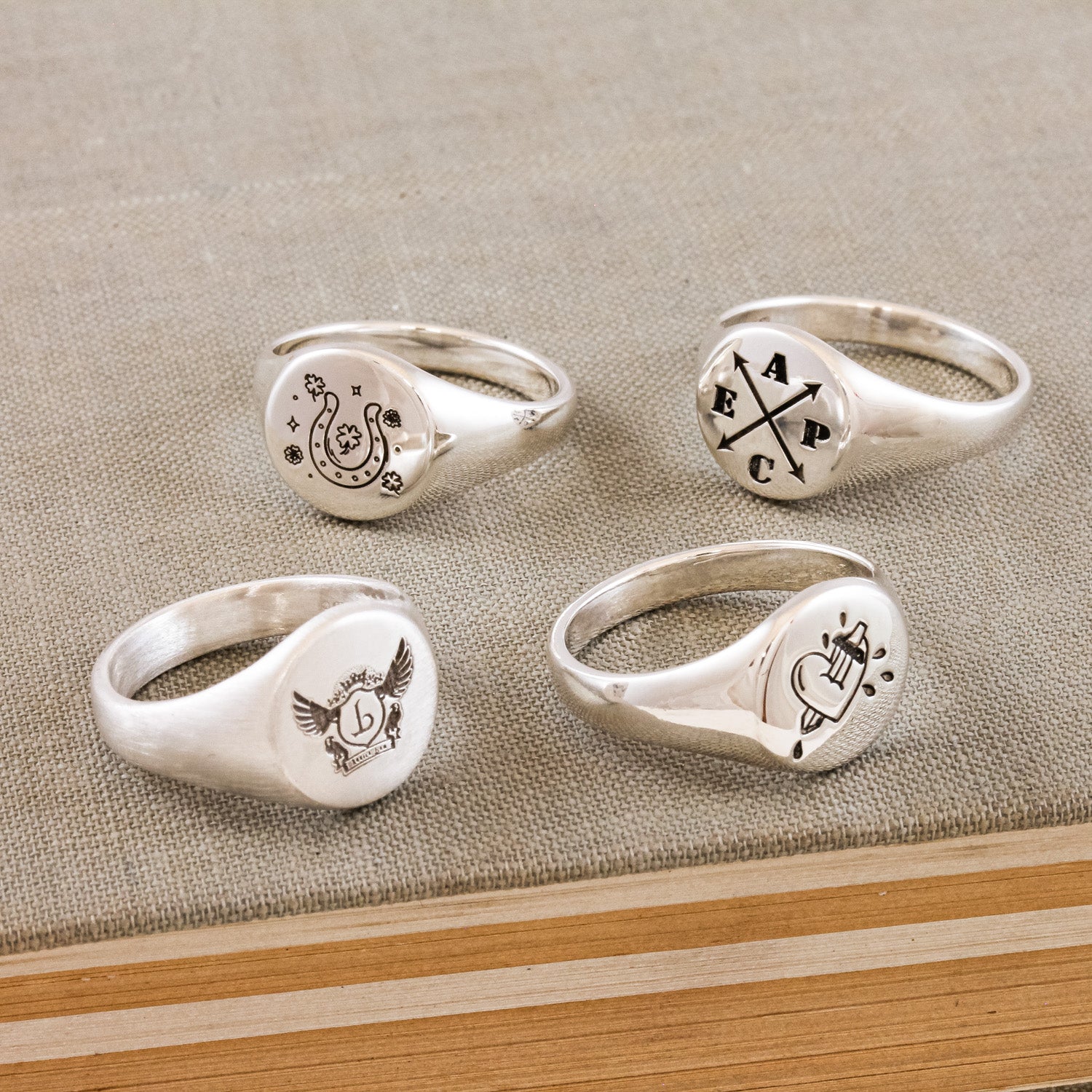 custom engraved silver signet rings with various designs