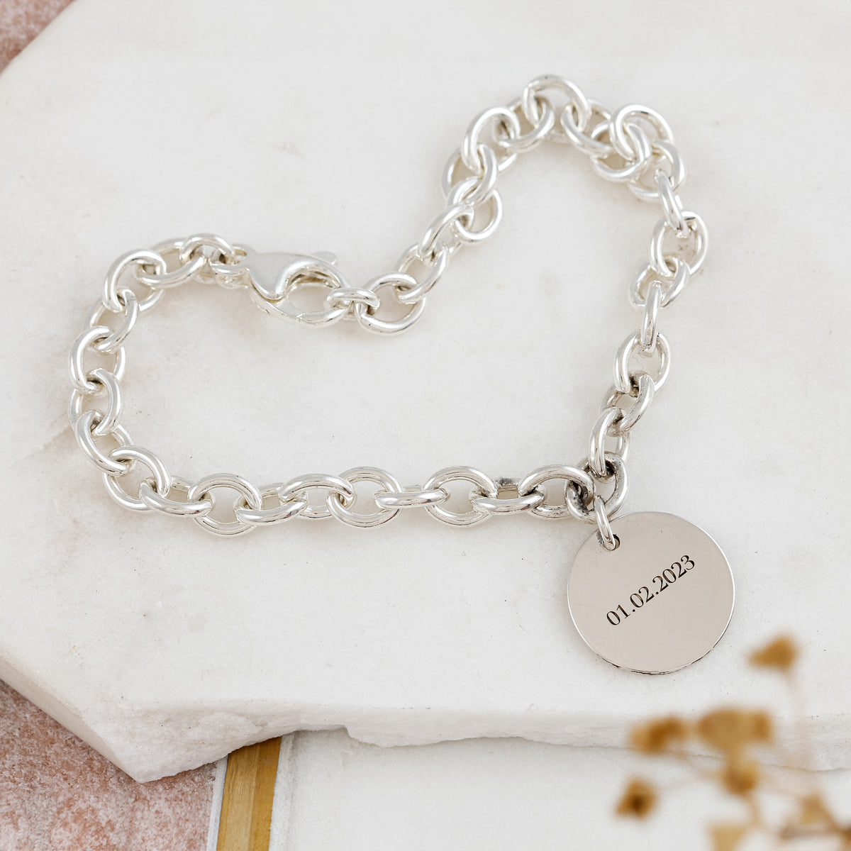 silver charm bracelet with engraved disc charm