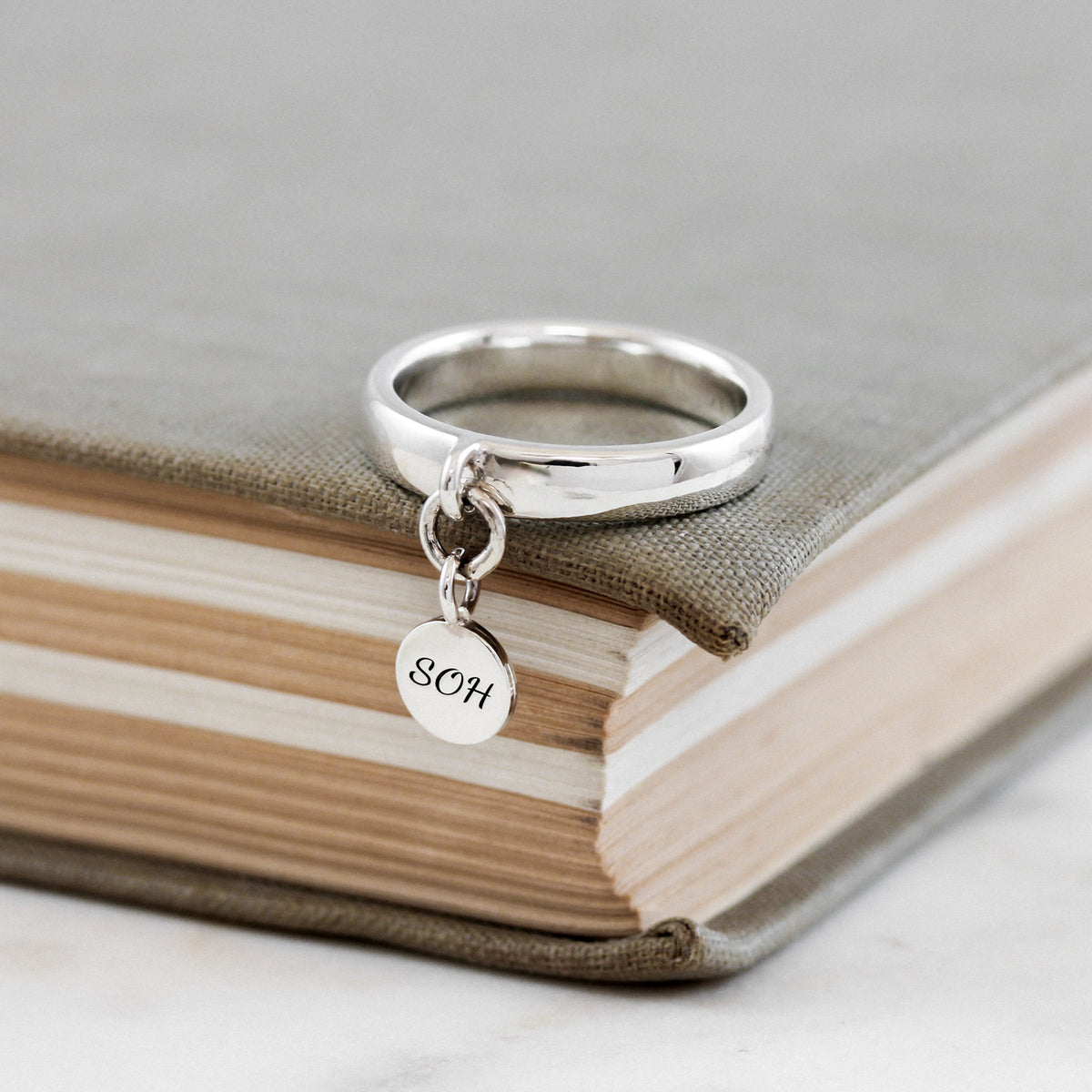 silver charm ring with personalised initials tag