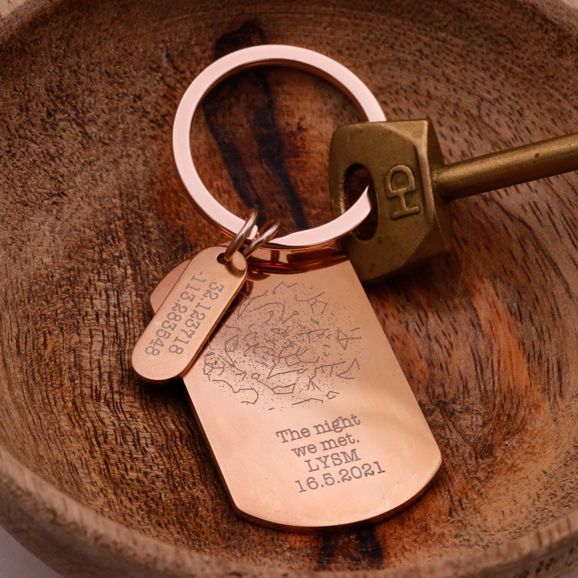 Keychain with engraved tag on a wooden surface