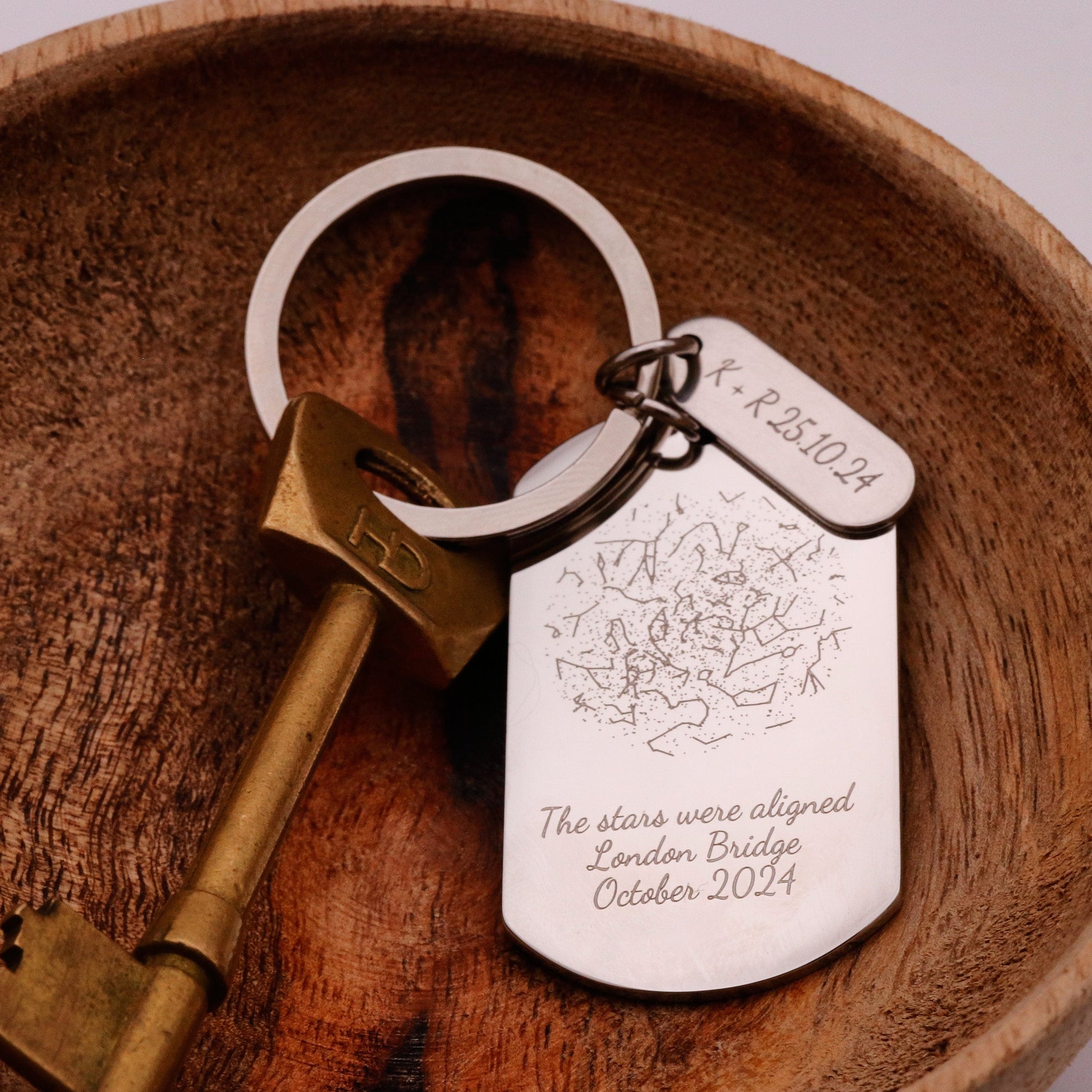 Keychain with engraved tag on a wooden surface