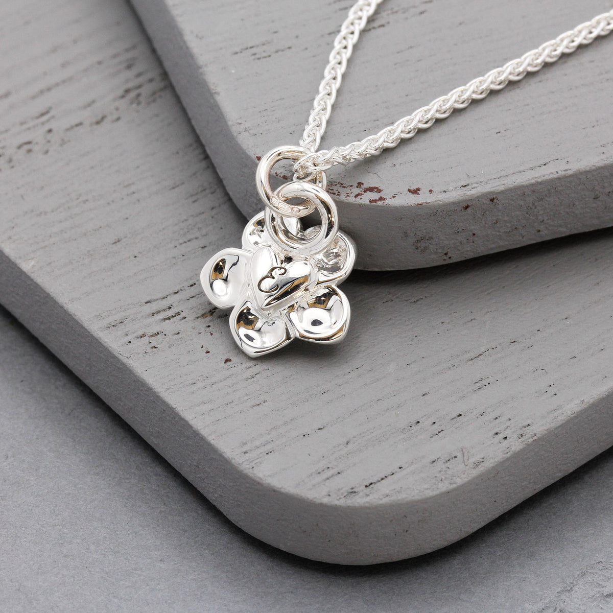 forget me not flower engraved initial on back of pendant