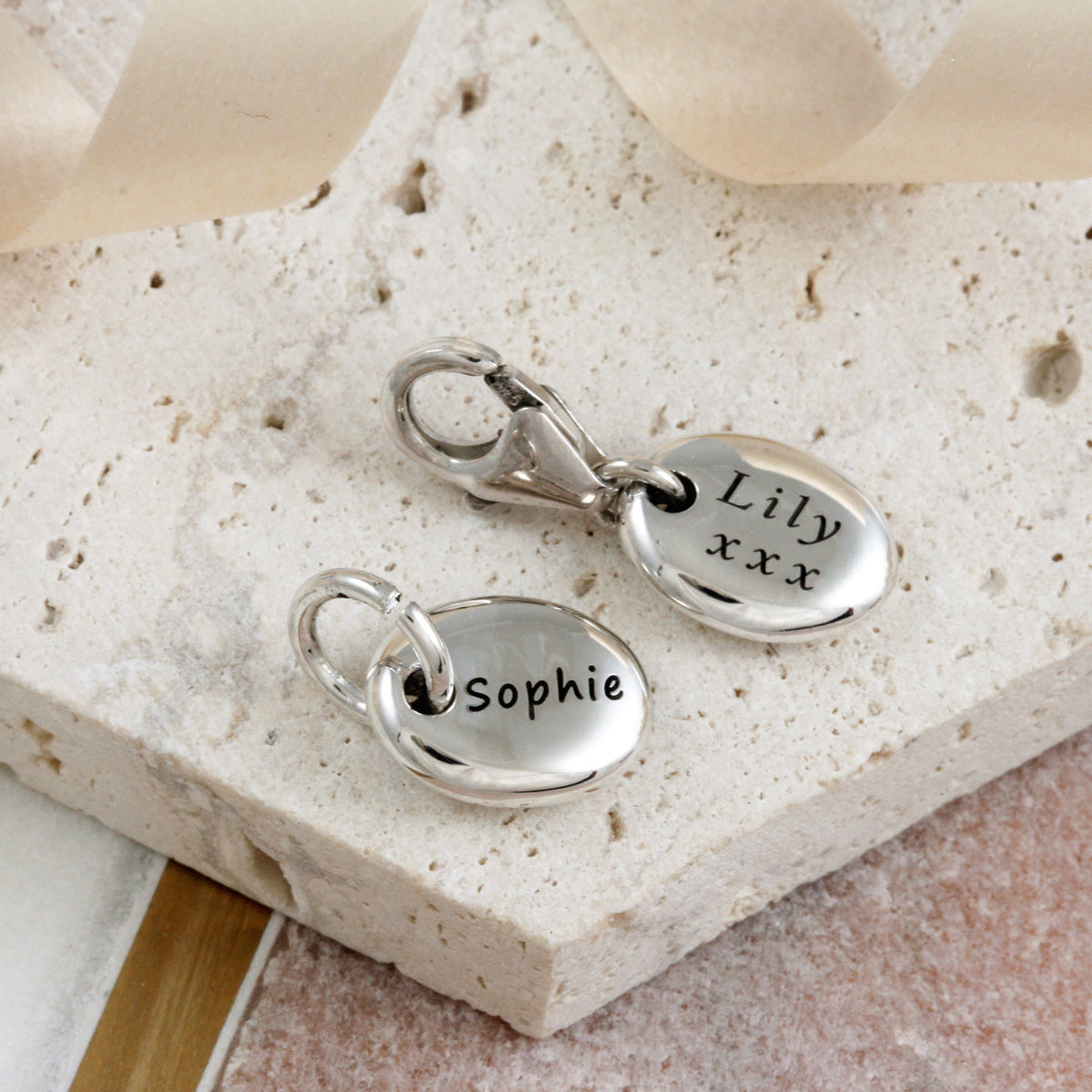 silver engraved pebble charm with open and clip on clasps