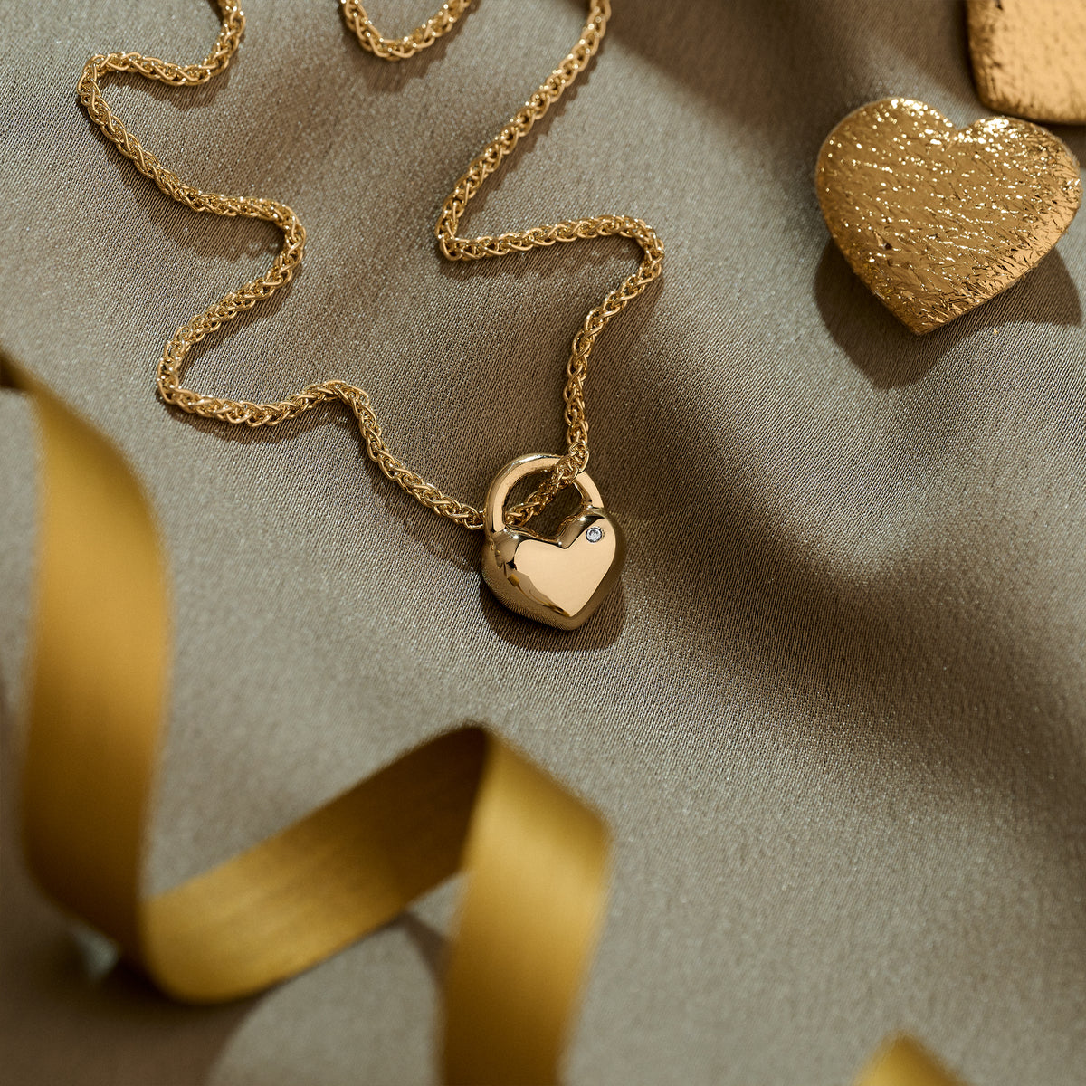 solid gold rounded heart necklace set with diamond on heavier gold spiga wheat chain