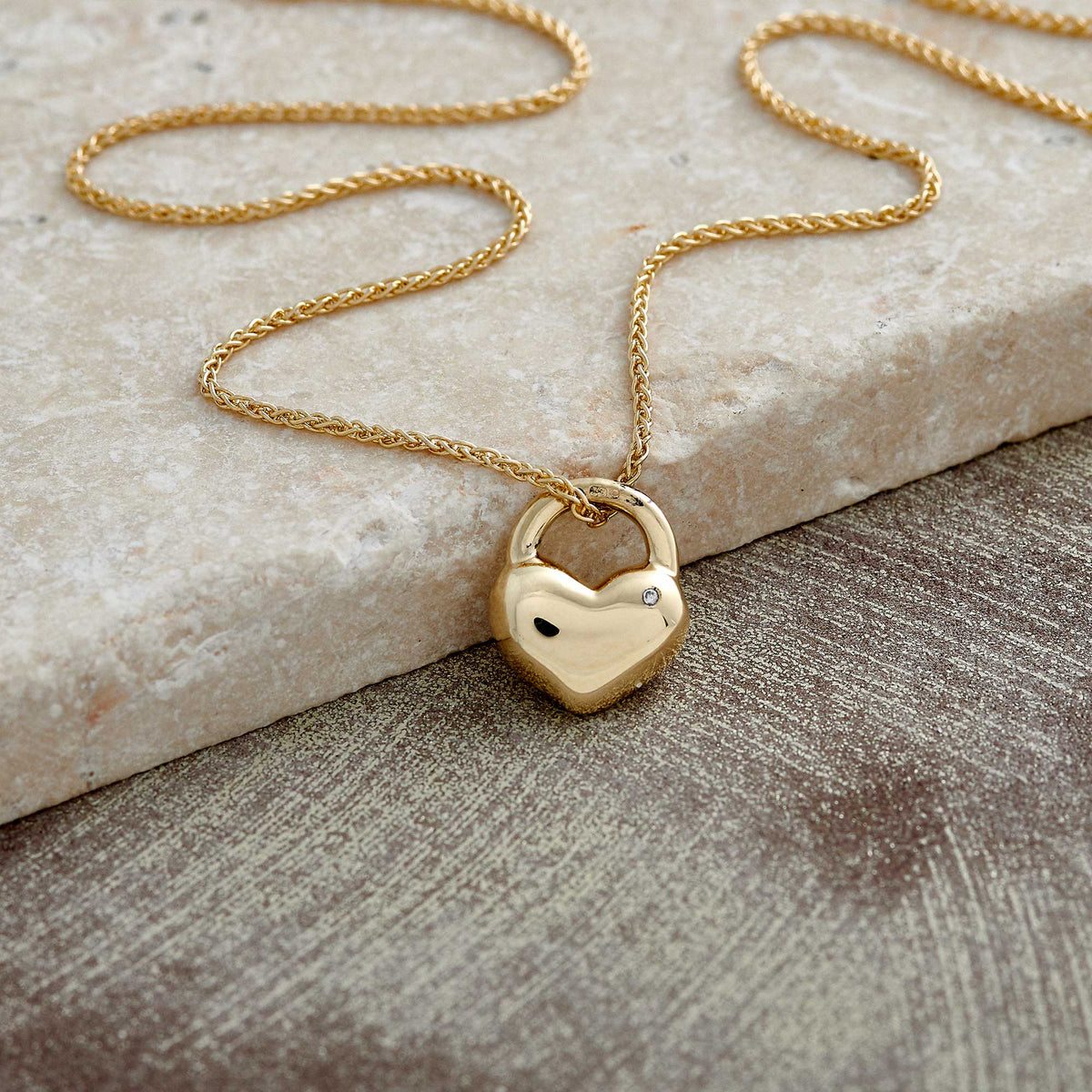 solid gold rounded heart necklace set with diamond on light gold spiga wheat chain