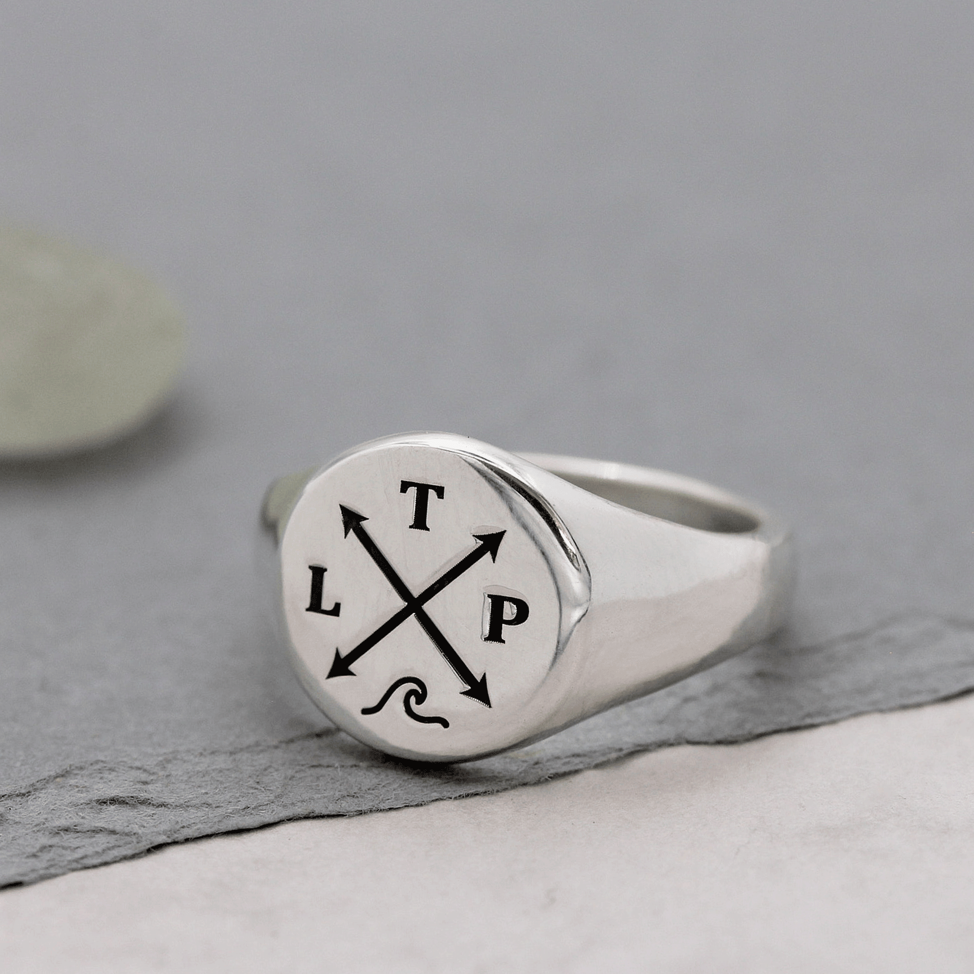 silver signet ring with initials and wave symbol