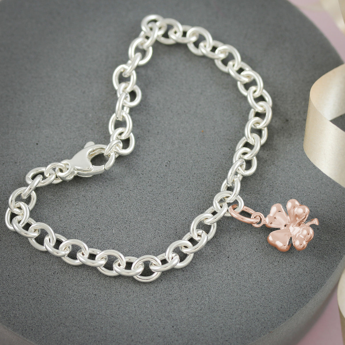 rose gold plated four leaf clover charm on silver bracelet