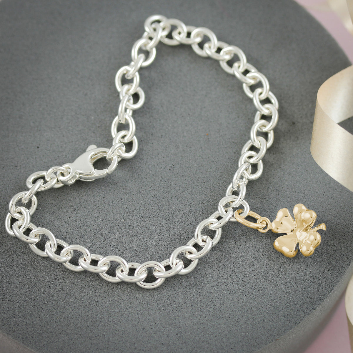 gold plated four leaf clover charm on silver bracelet