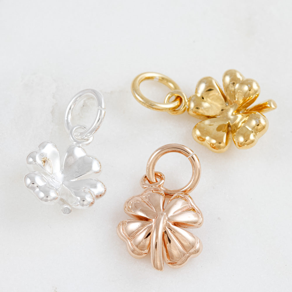 front and back of four leaf clover silver charms