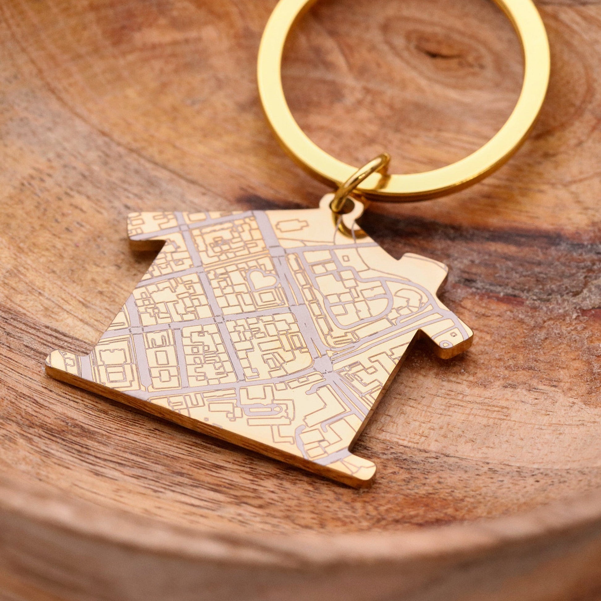Gold house shaped silver keyring with map design