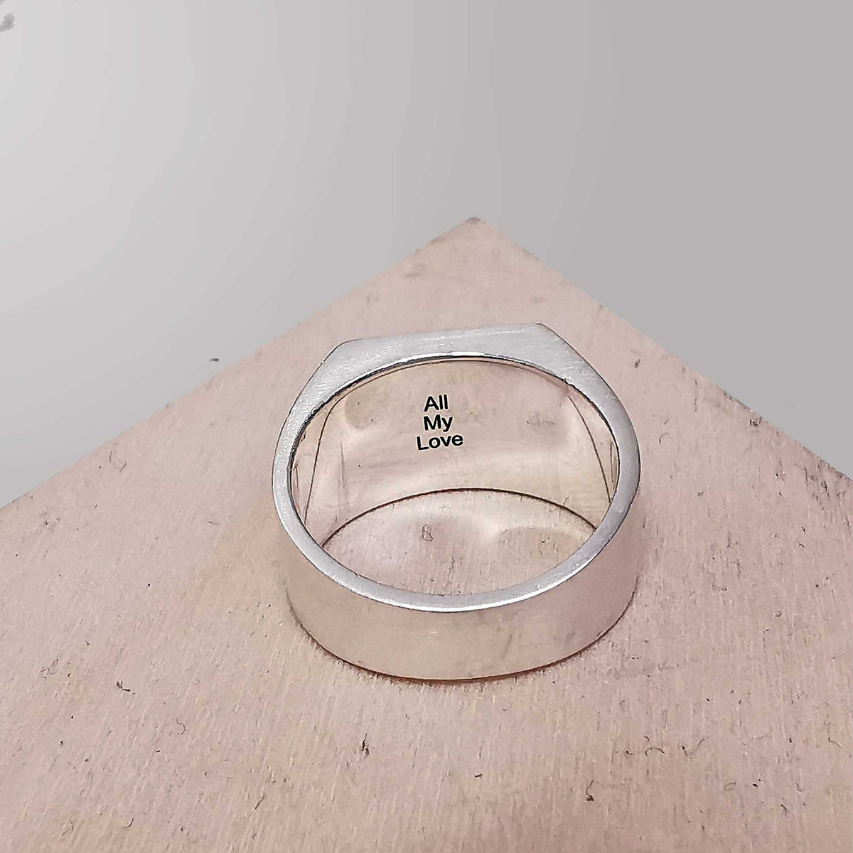 inside engraving in large square signet ring