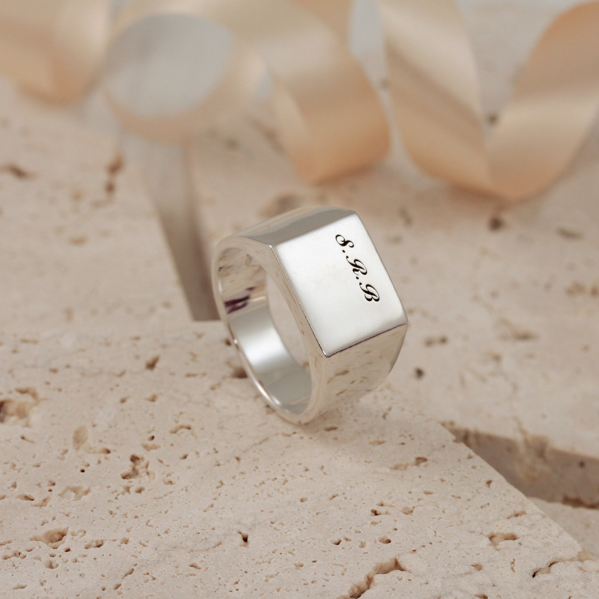 large square silver signet ring with engraved initials script font